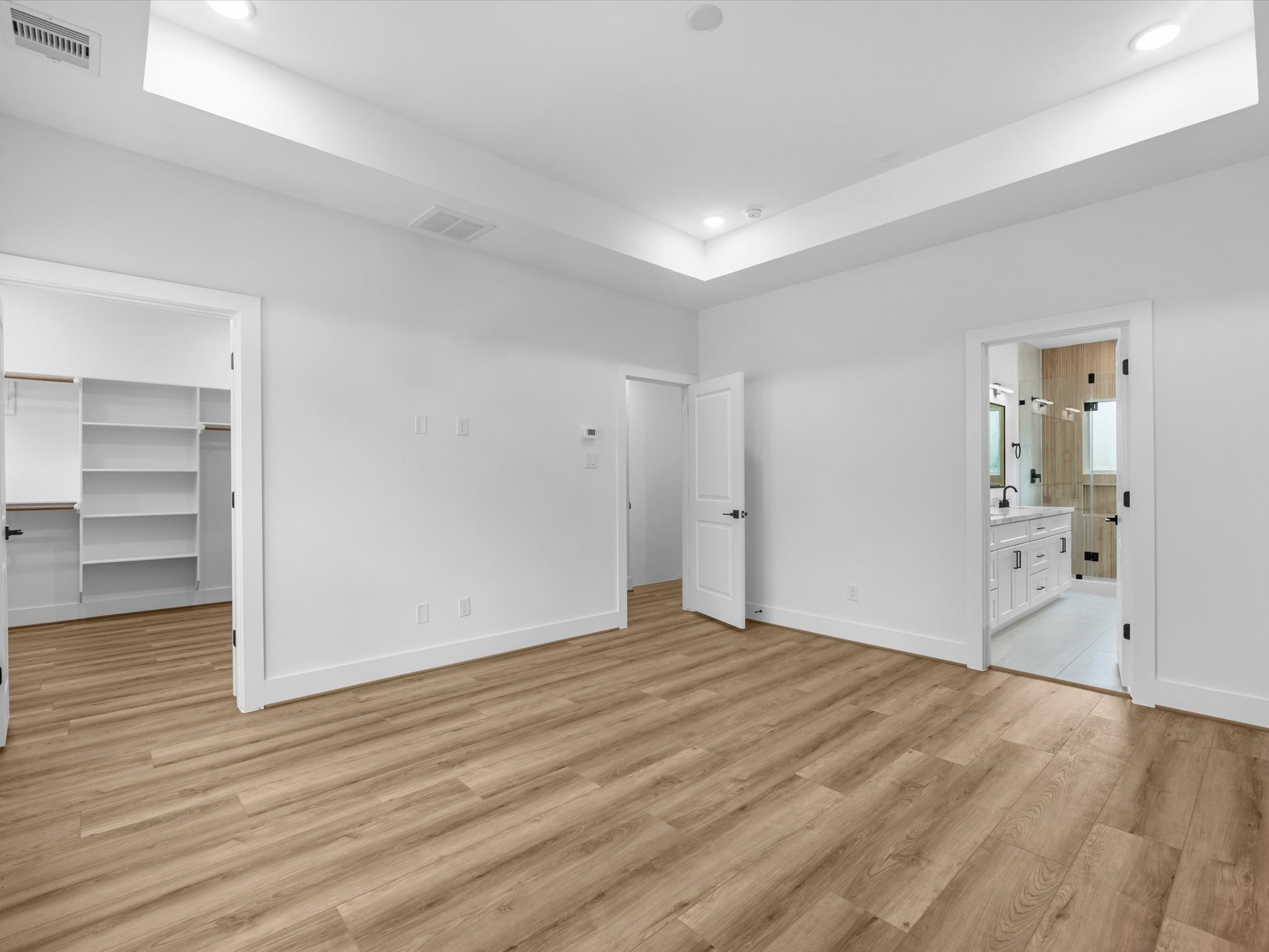 Private and spacious primary bedroom featuring beautiful tray ceilings and a peaceful third-floor location. Set apart from the main living spaces, the third-floor primary suite offers added privacy and a comfortable retreat.