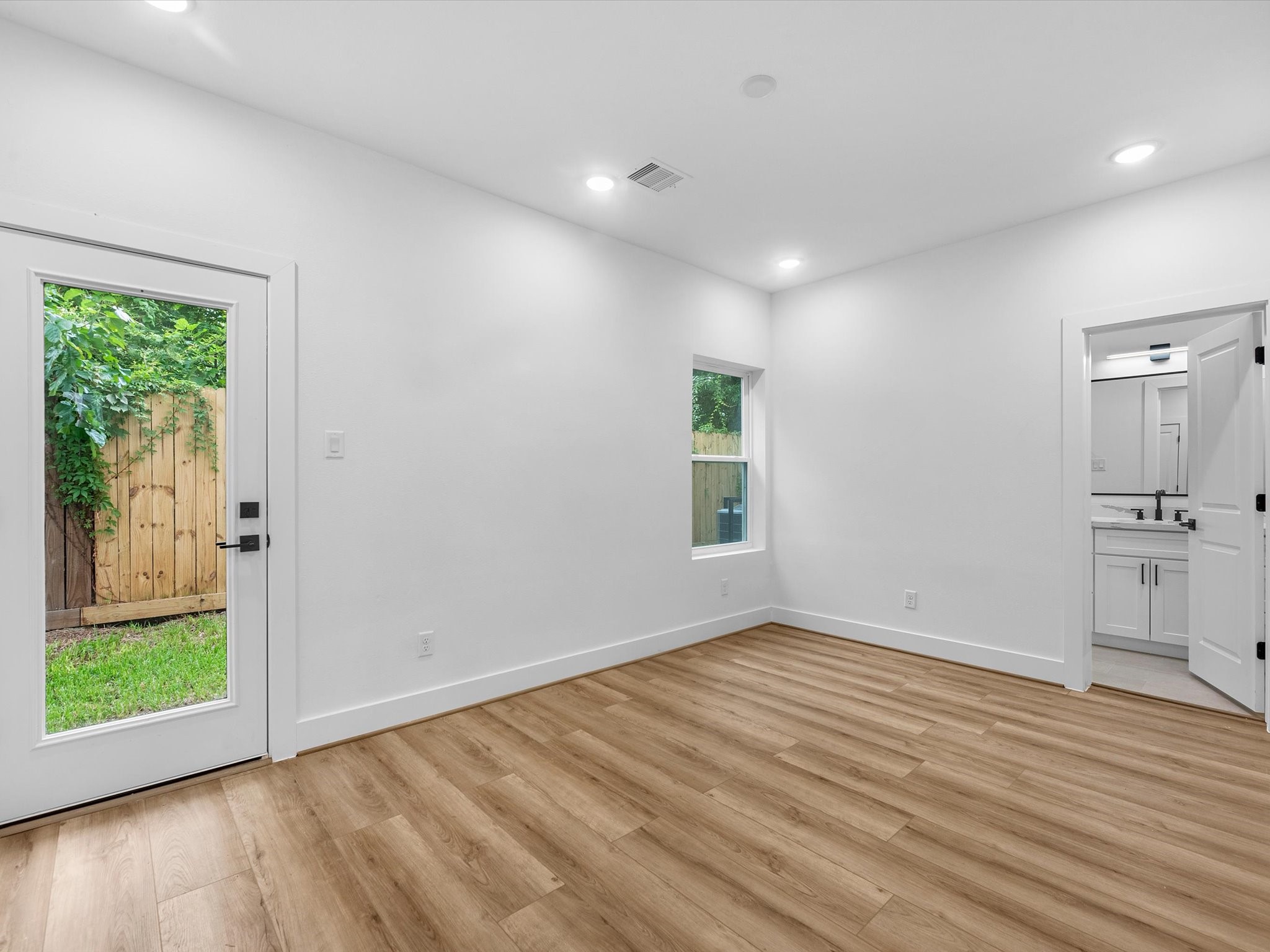 Convenient first-floor bedroom offering privacy and flexibility, with a door leading directly to the backyard. Perfect for guests, an office, or anyone looking for easy access to the outdoor space.