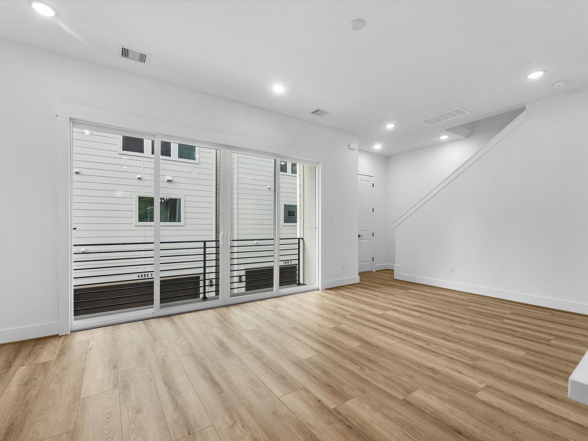 Large sliding glass doors create a seamless indoor-outdoor feel, opening directly to the private balcony. Perfect for bringing in natural light and extending the living space outdoors.