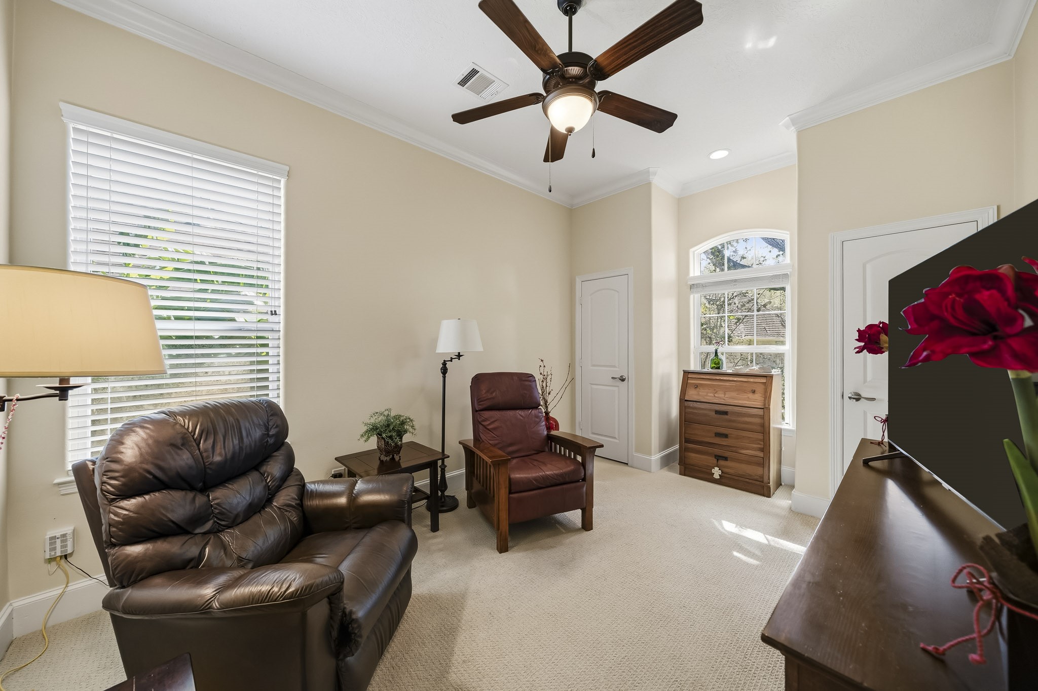 his versatile Secondary Bedroom is currently styled as an additional Living Room, showcasing the remarkable flexibility of the space. Whether utilized as a Bedroom, media room, home office, or lounge, the generous layout easily adapts to a variety of lifestyle needs. Adding to its appeal, this room is uniquely equipped with two closets, providing exceptional storage and organizational possibilities.