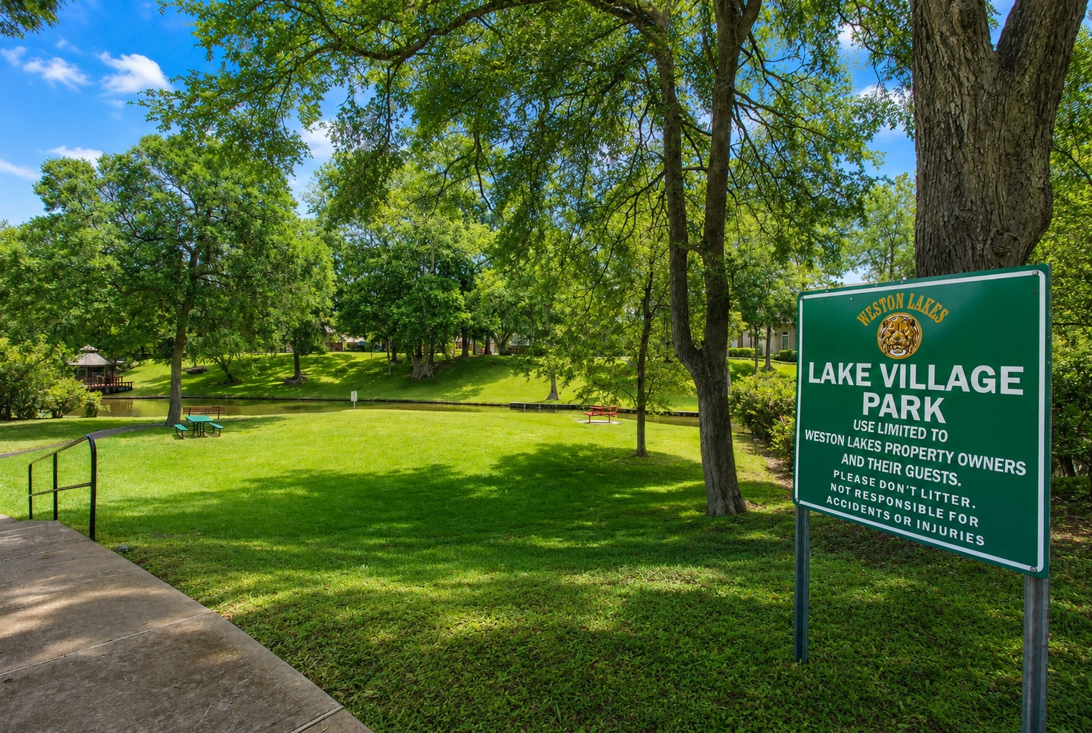 Lake Village Park is a private neighborhood park reserved exclusively for Weston Lakes residents and their guests. Nestled beneath a canopy of majestic oak trees, this scenic waterfront retreat offers lush green space, tranquil canal views, picnic areas, and peaceful walking pathscreating the perfect setting for morning strolls, family gatherings, or quiet afternoons surrounded by nature.