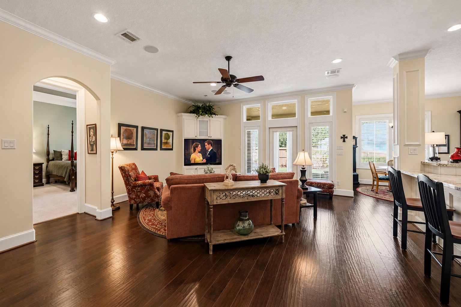 Continuous wood flooring extends into the Family Room, enhancing the home's effortless flow and unified design. Rich crown molding, oversized baseboards, integrated speakers, and beautifully crafted custom built-ins add layers of sophistication, creating a space that is both refined and exceptionally comfortable. Continuous wood flooring extends into the Family Room, enhancing the home's effortless flow and unified design. Rich crown molding, oversized baseboards, integrated speakers, and beautifully crafted custom built-ins add layers of sophistication, creating a space that is both refined and exceptionally comfortable.
