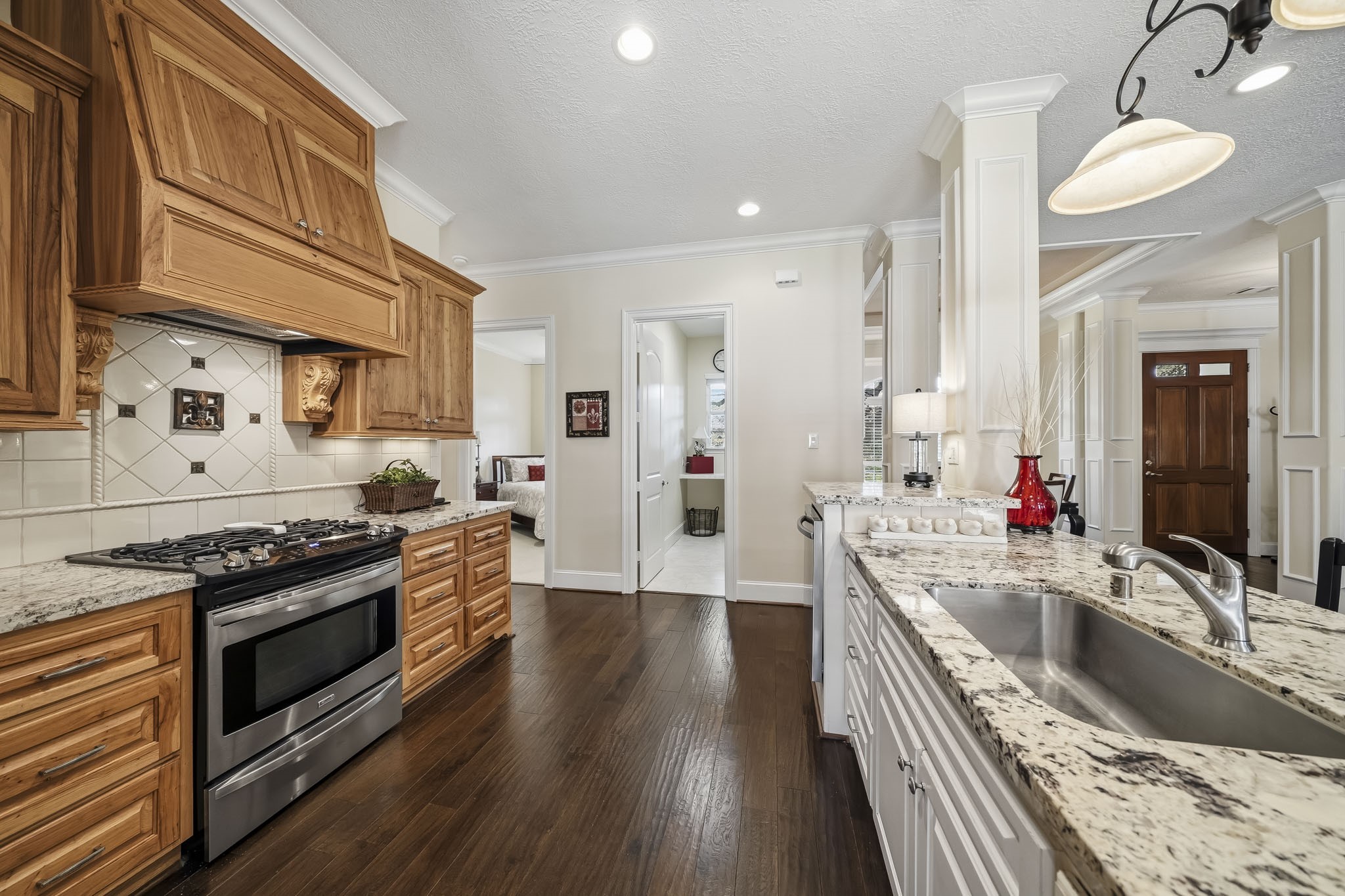 Complementing the Kitchen's timeless design is a suite of stainless-steel appliances, featuring a 4-burner gas range, built-in microwave, and whisper-quiet dishwasher. Combining professional-grade performance with sleek sophistication, this premium appliance package enhances both the beauty and functionality of the space.