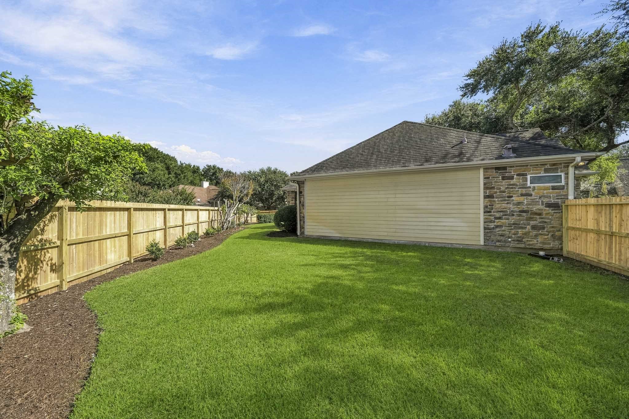 This spacious Side Yard offers a blank canvas for bringing your outdoor vision to life. Whether you dream of flourishing raised garden beds, a custom playset, an outdoor entertaining area, or even a private putting green, the generous space provides endless opportunities for recreation, relaxation, and personalization.