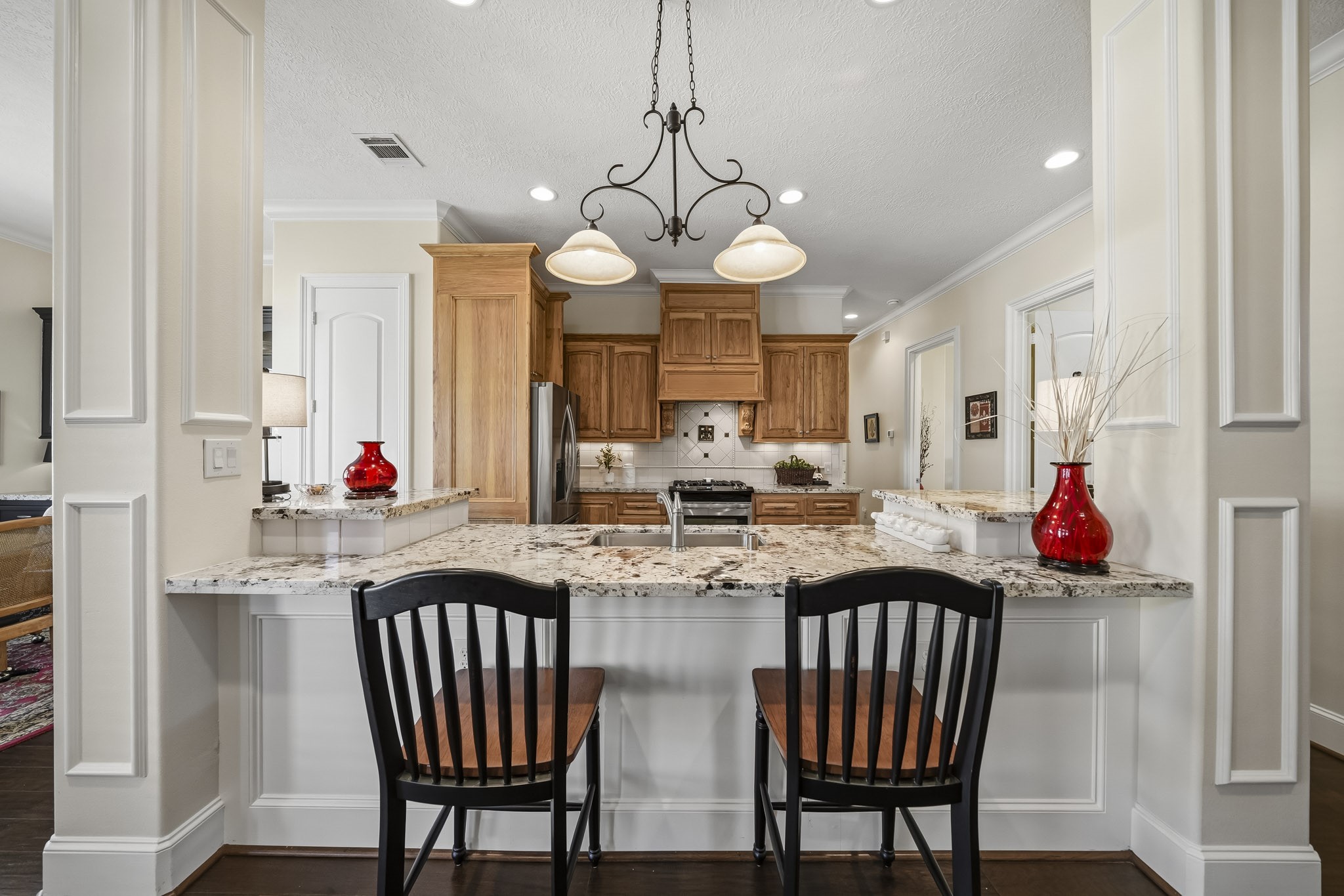 The counter-height Bar offers additional seating and serves as a natural gathering place at the heart of the home. Whether enjoying a leisurely Sunday breakfast, helping with homework after school, or decorating cookies during the holidays, this versatile space is perfectly suited for creating everyday moments and cherished family traditions.