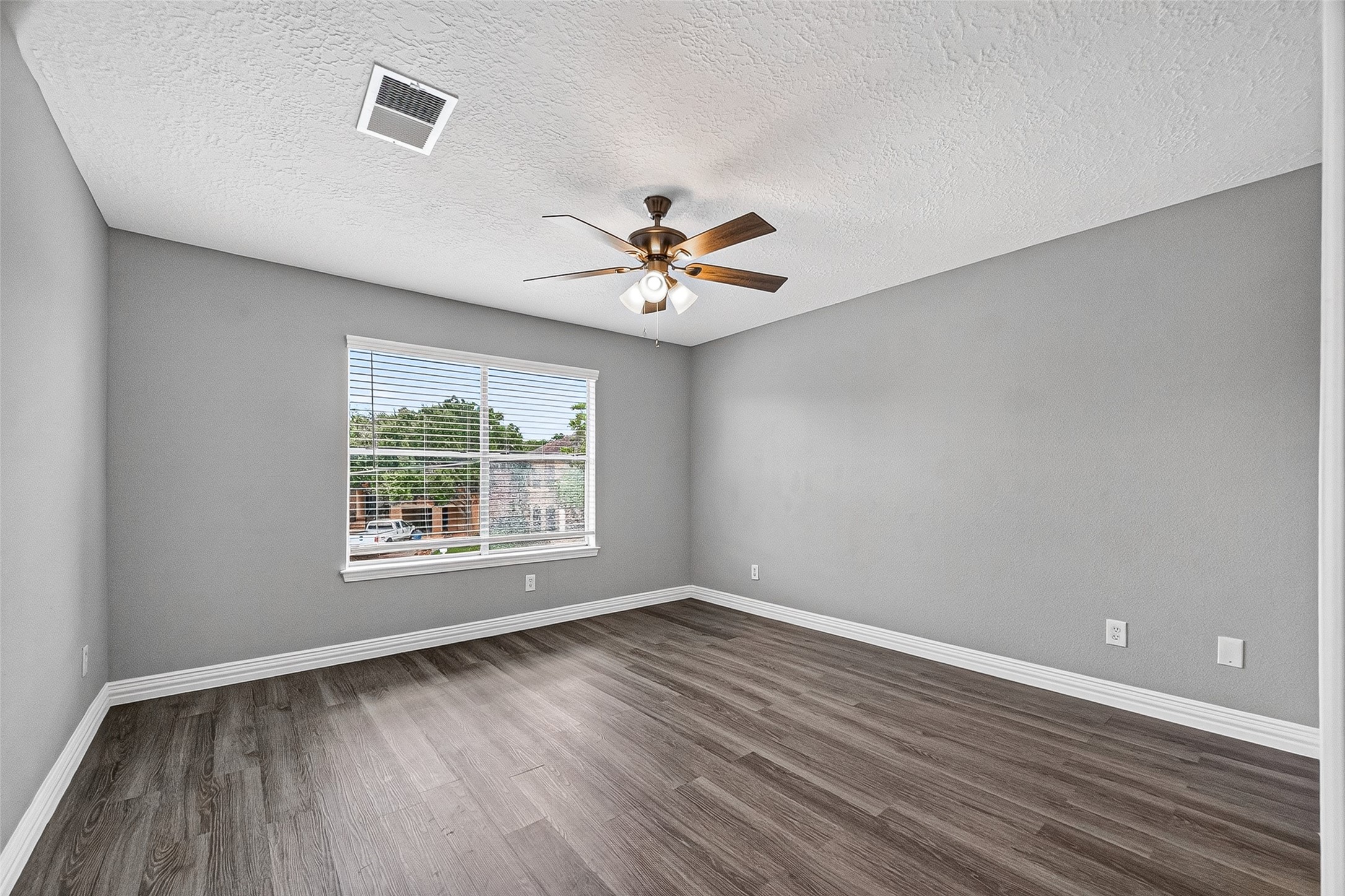 Bedroom with a large window and fresh neutral paint