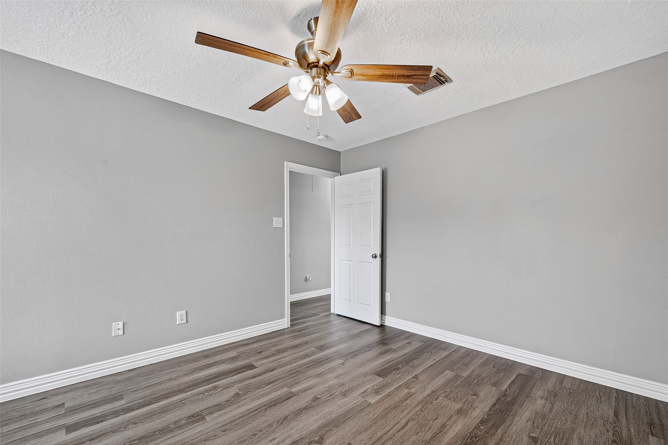 Generously sized bedroom with ceiling fan
