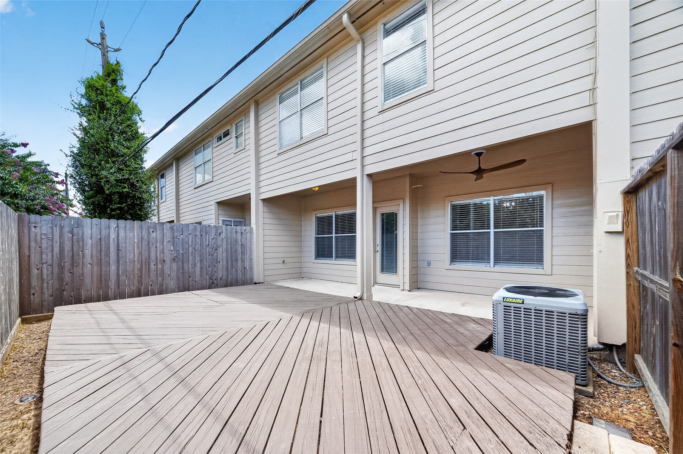Low-maintenance backyard with deck and privacy fence