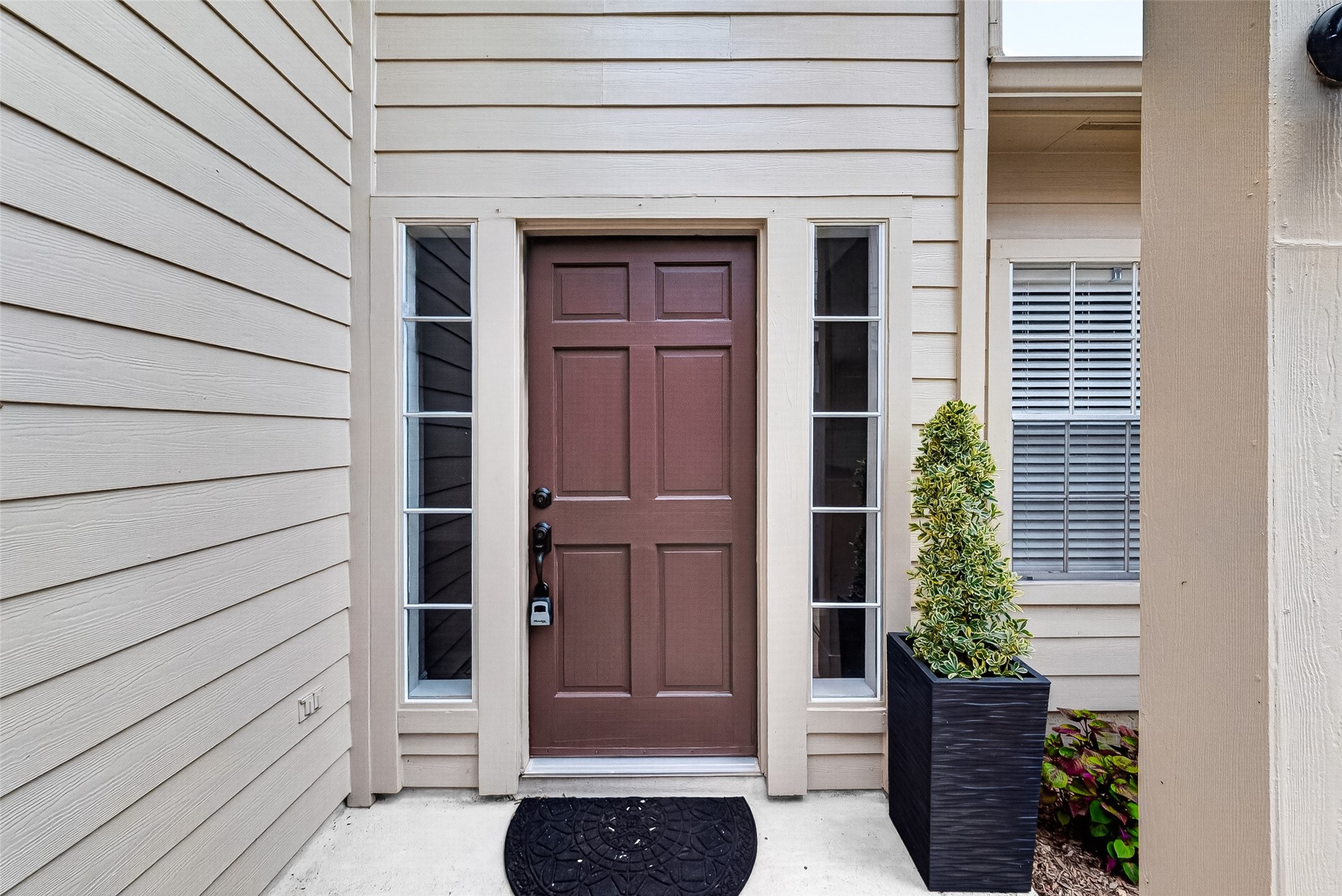 Inviting front entry with a classic wood-tone door