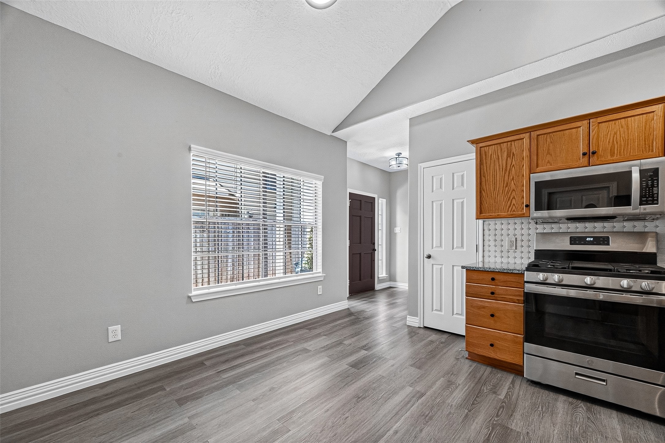 Kitchen overlooks the living space with vaulted ceilings