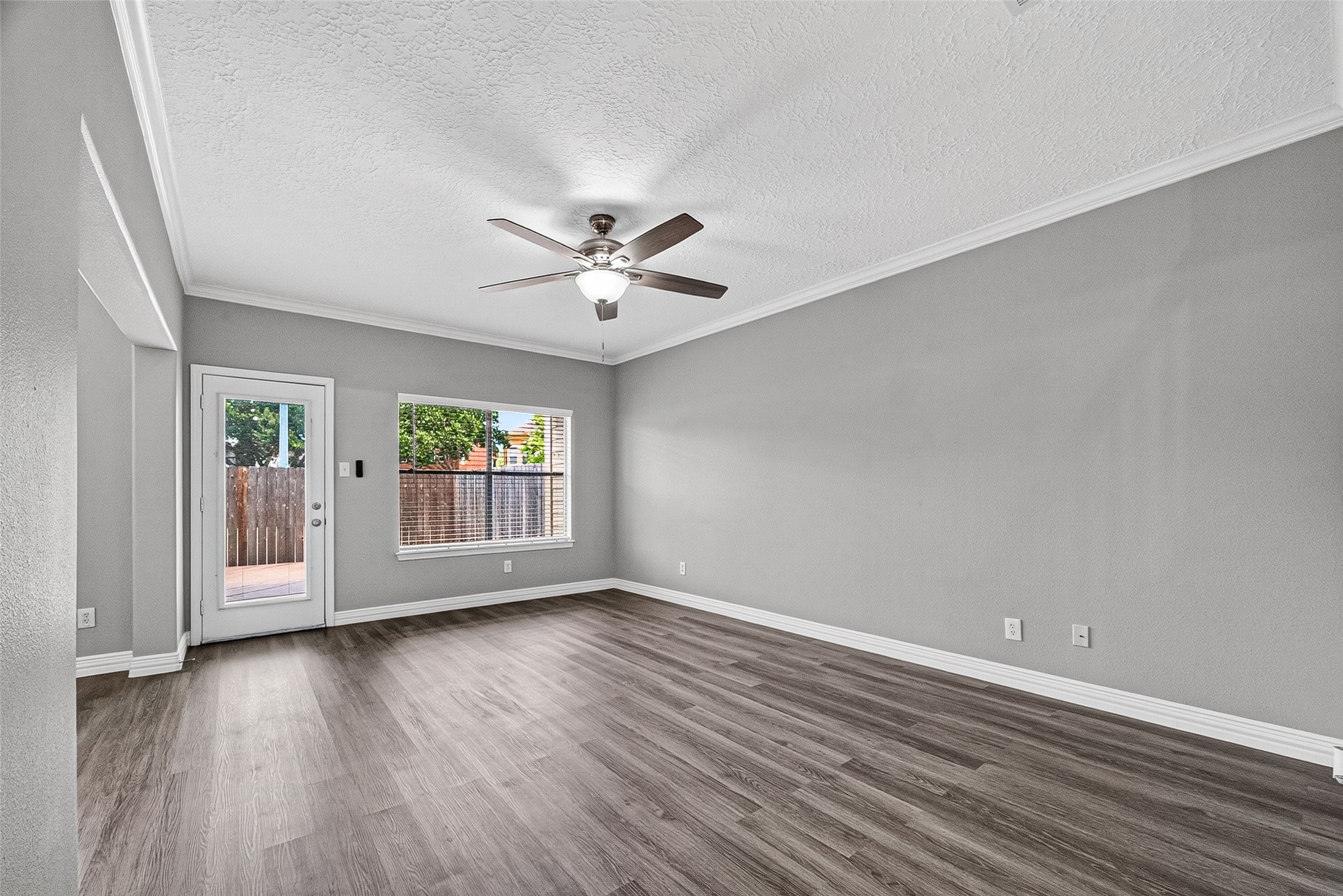 Light-filled living room with wood-look flooring throughout
