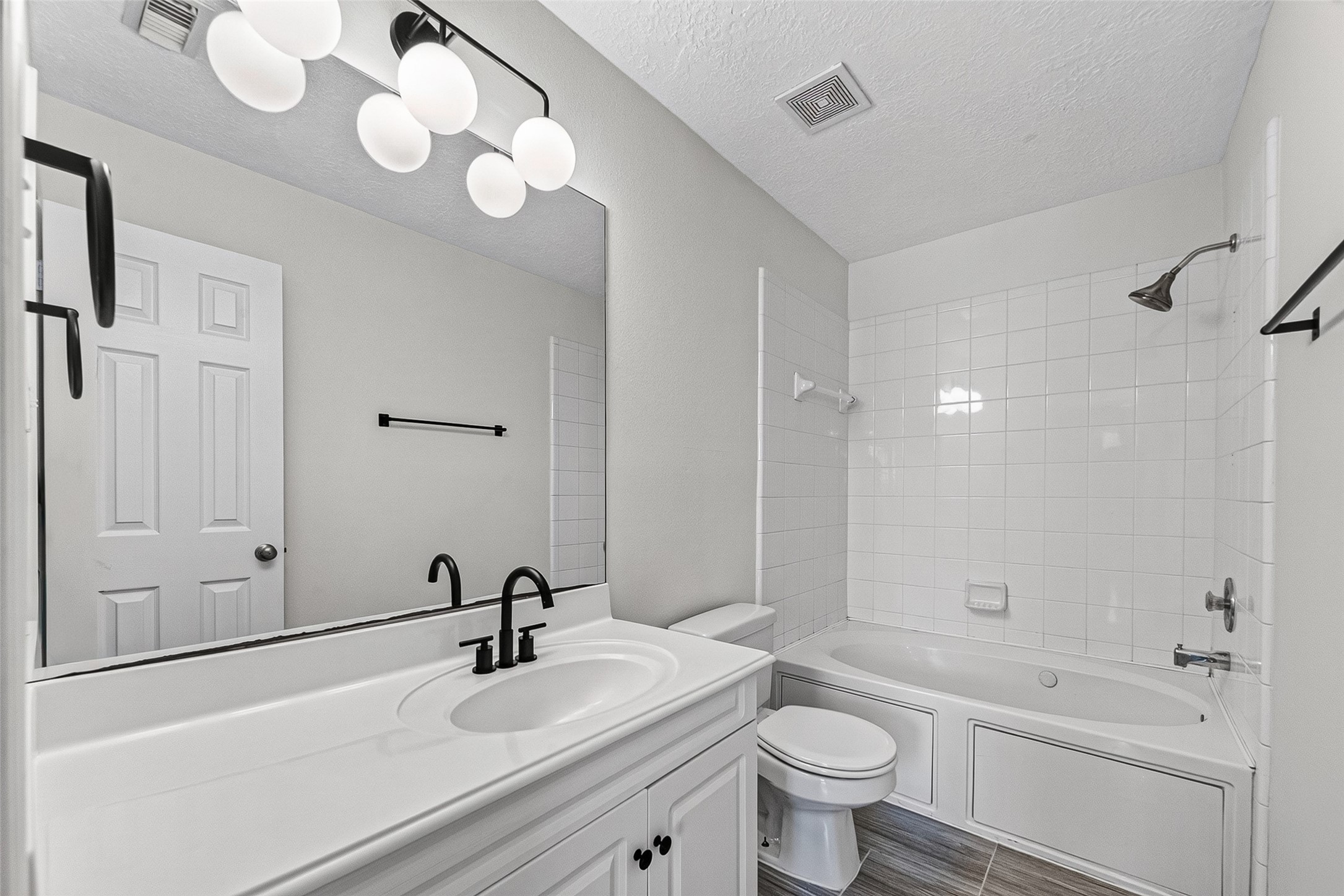 Bath with jetted tub/shower combo and contemporary lighting