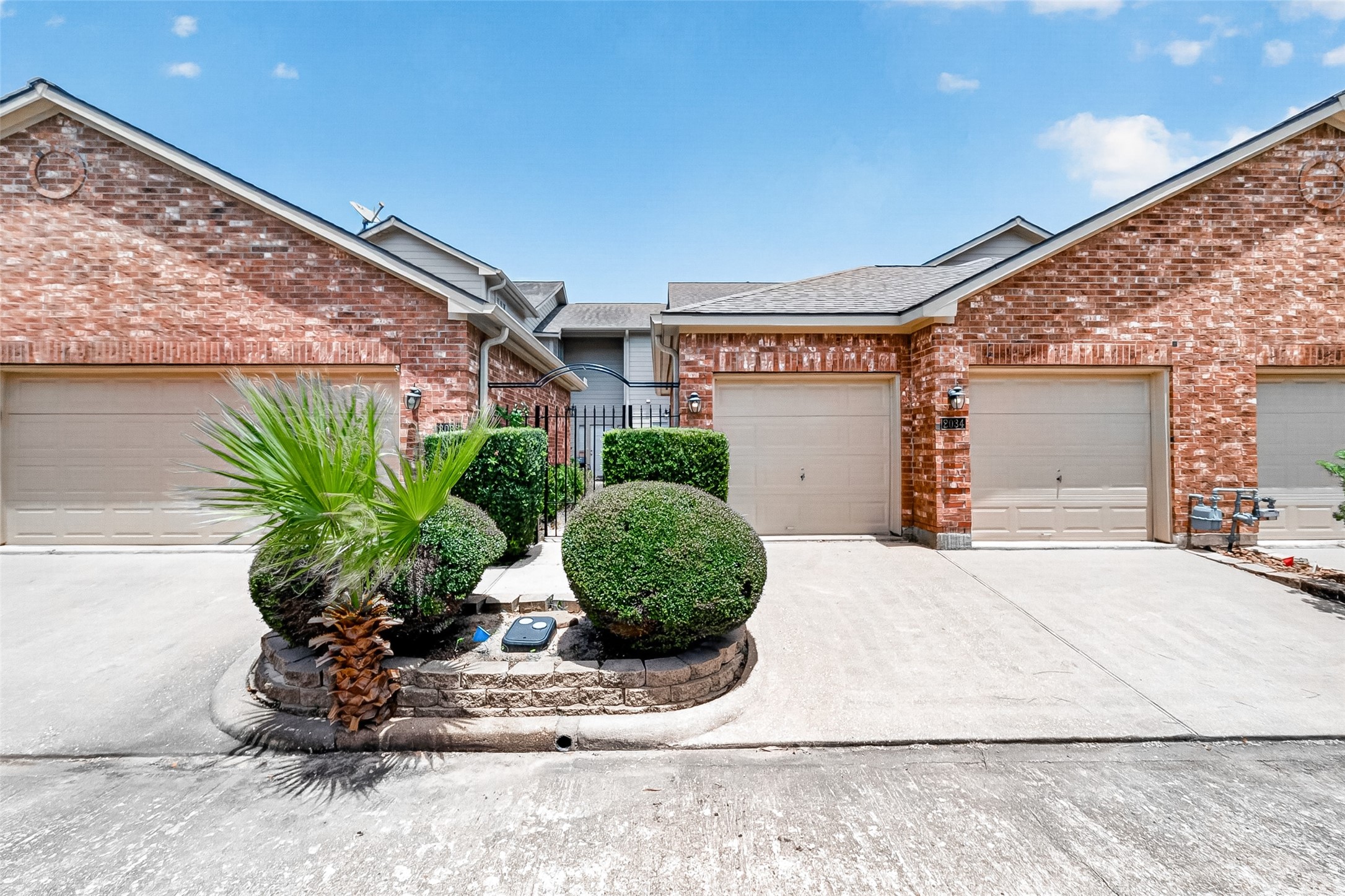 Inviting front exterior with classic brick and landscaping