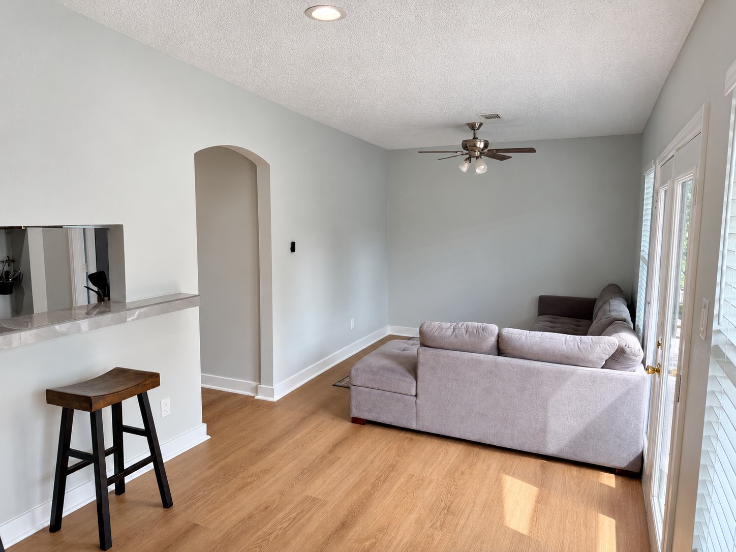 Alternate view of the living area and arched hallway entrance.