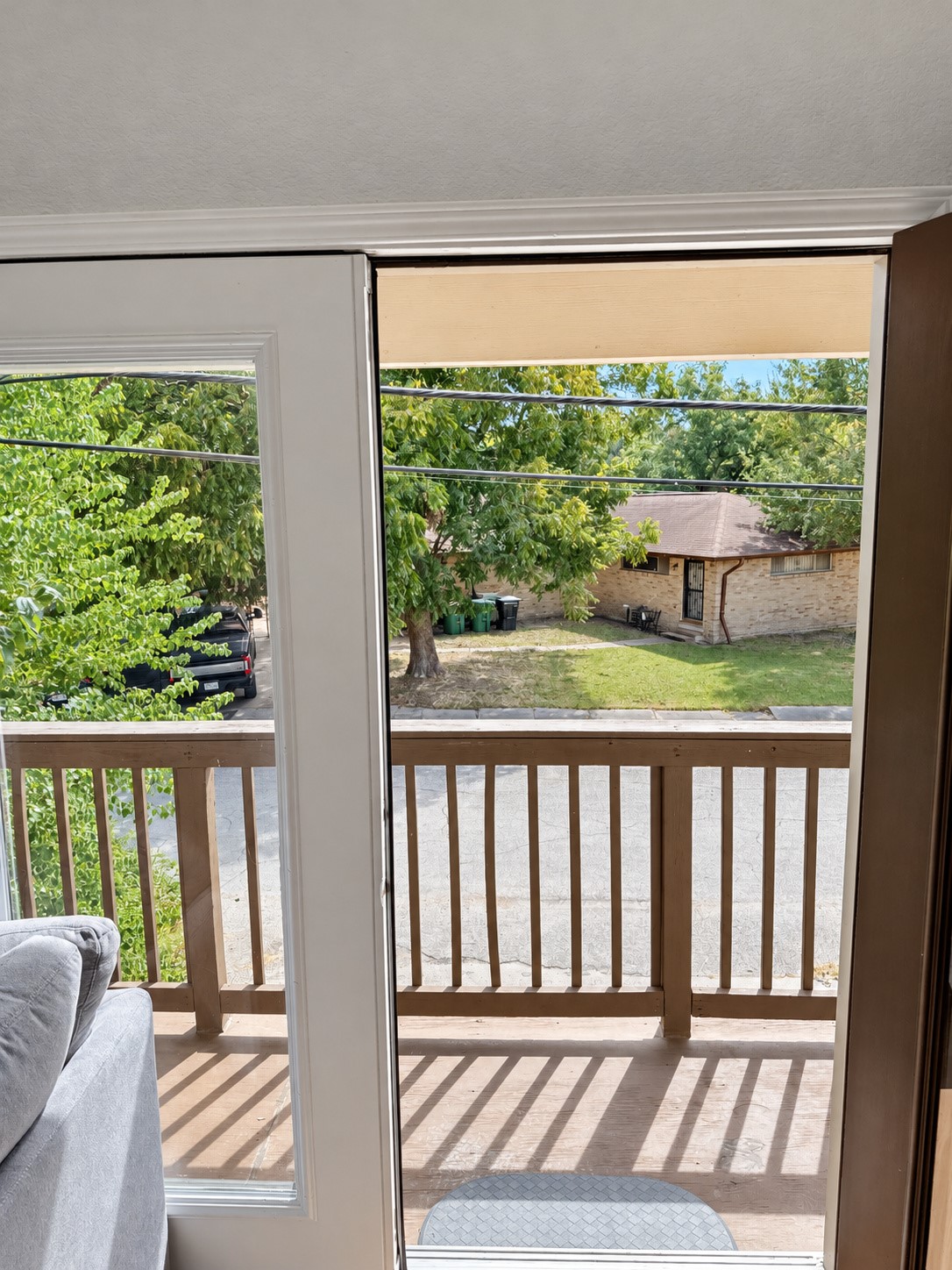 View from the living room toward the balcony and surrounding neighborhood.