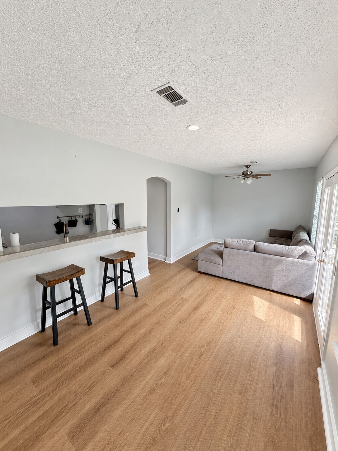 Open living area with a breakfast bar connecting to the kitchen.
