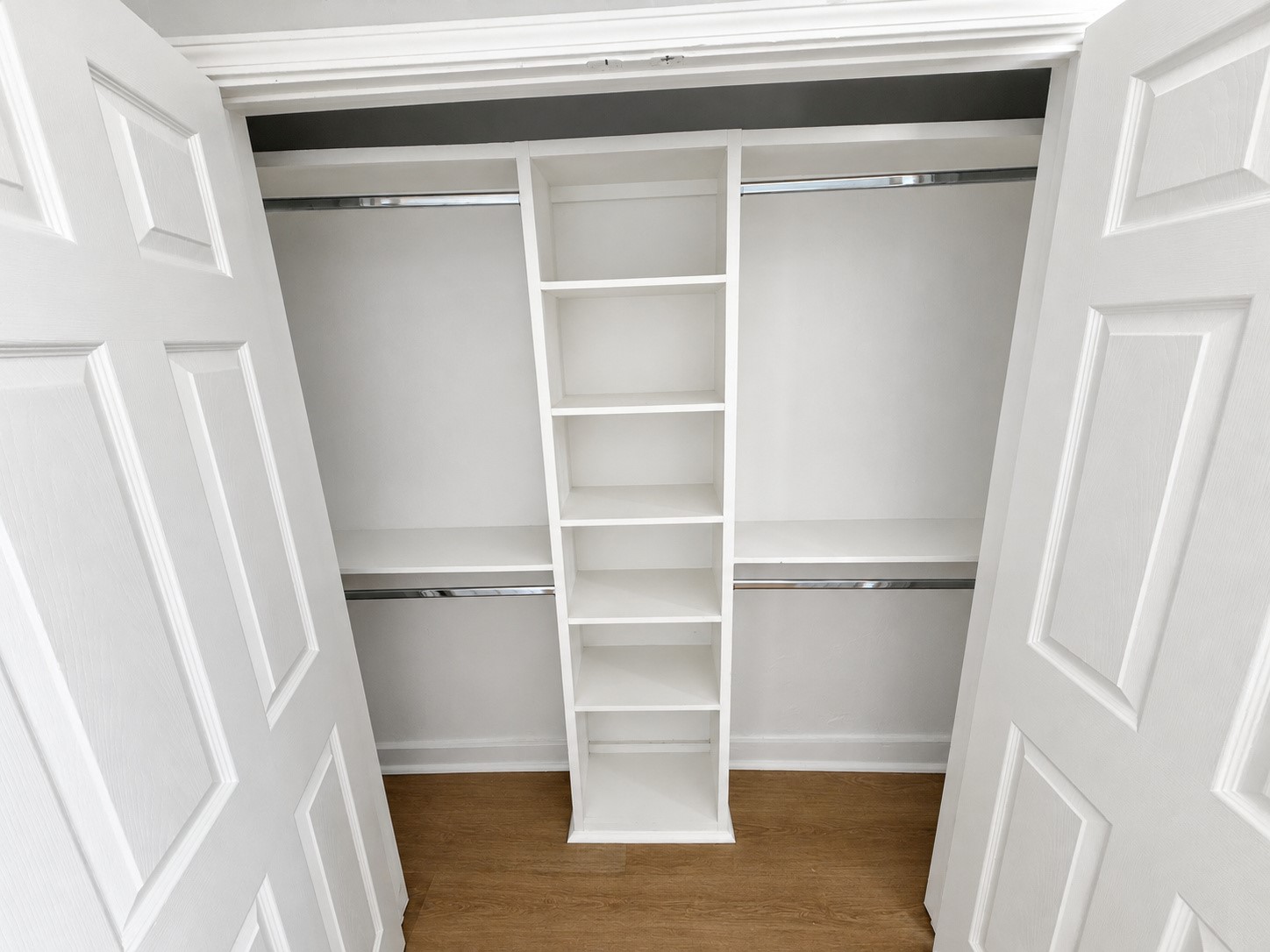 Both bedrooms have closets with built-in shelving and upper and lower hanging rods.