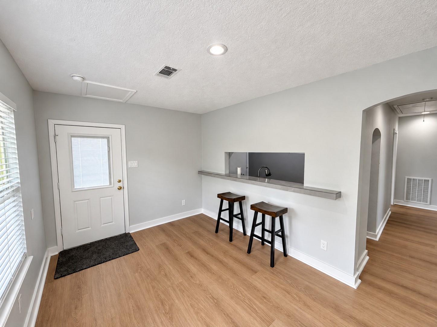 Breakfast bar seating and entry area with easy access to the kitchen.