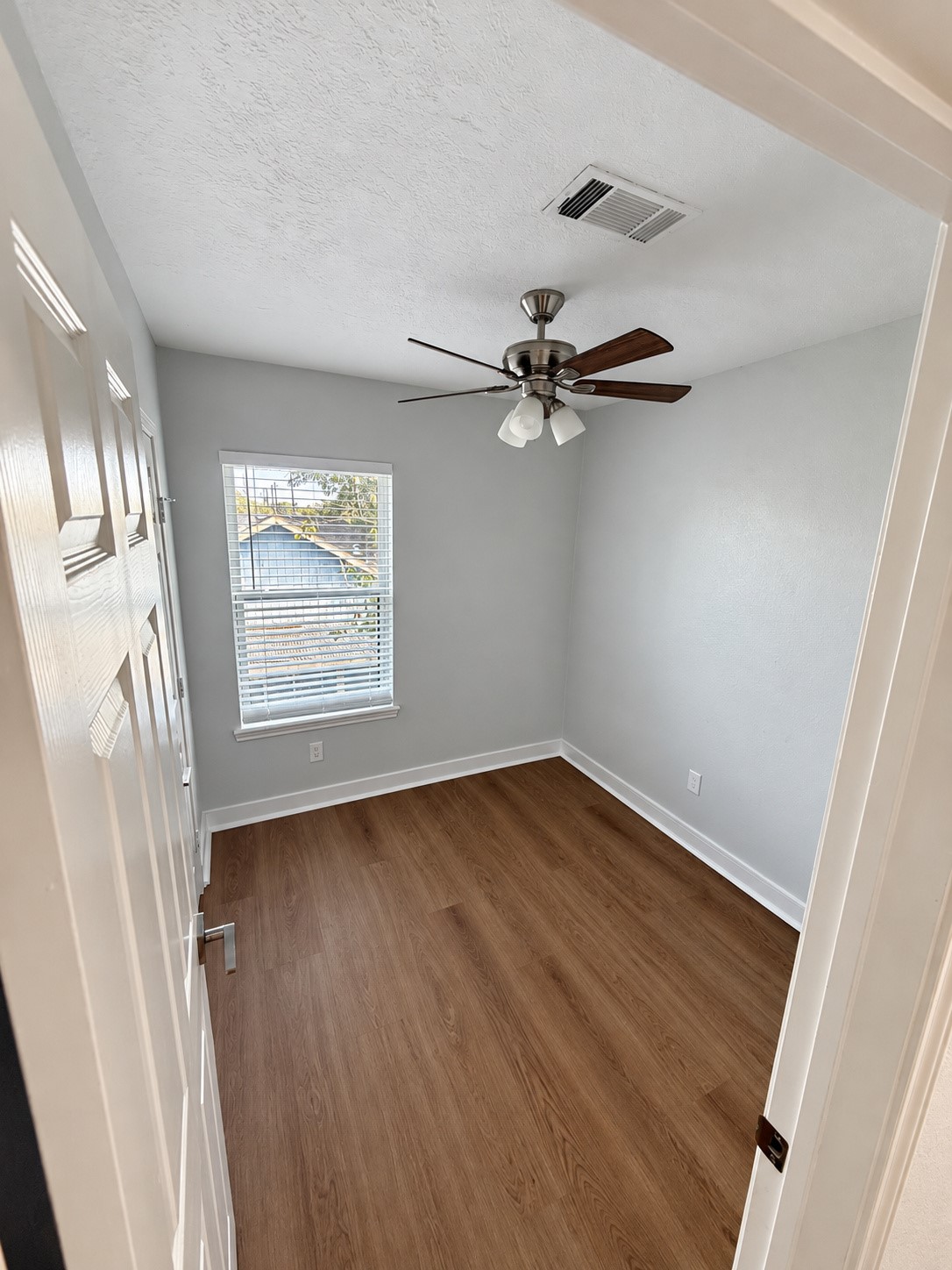 Compact second bedroom offers flexibility for use as a home office or study.