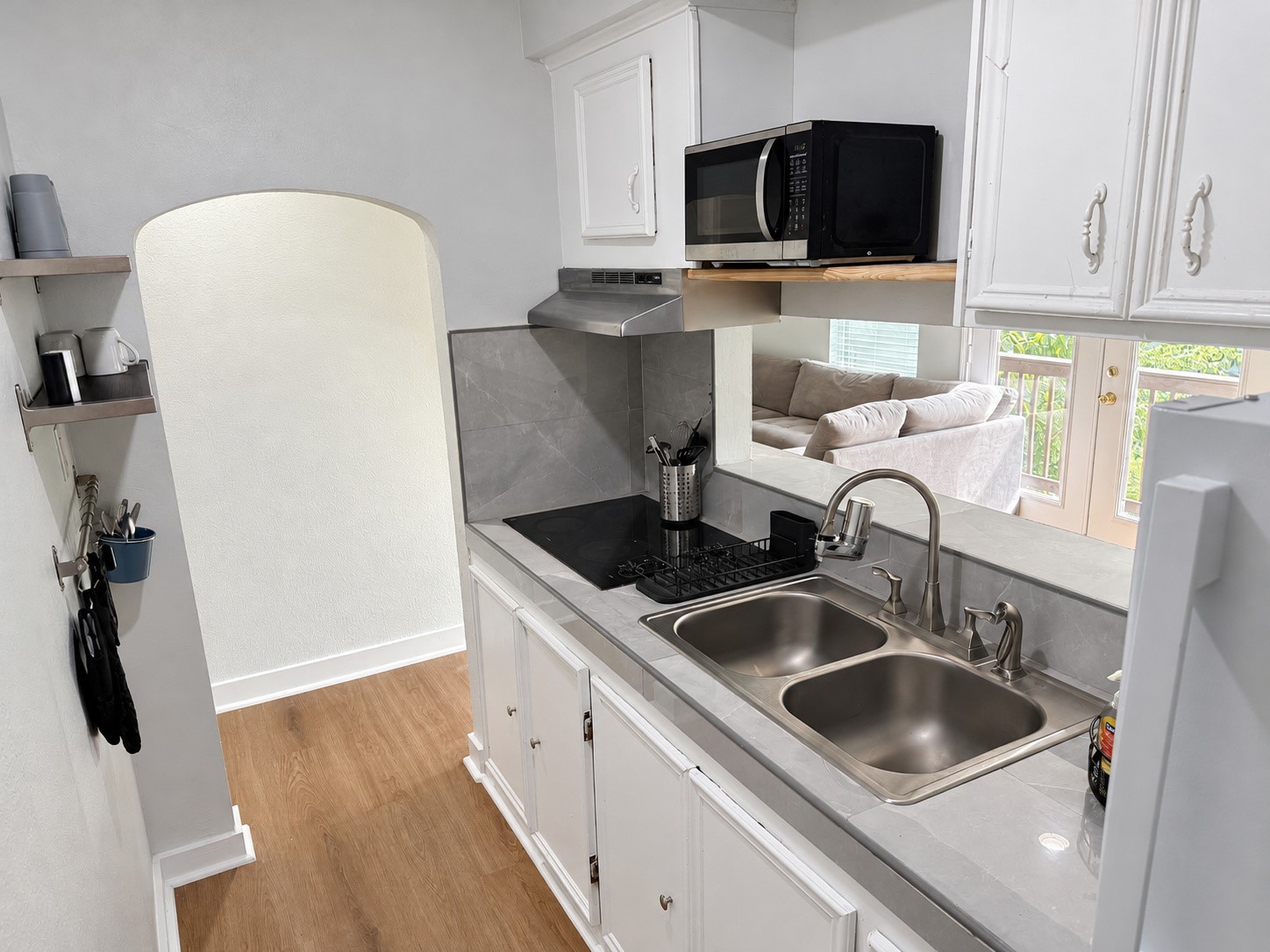 Kitchen with a double-basin sink and pass-through opening to the living area.