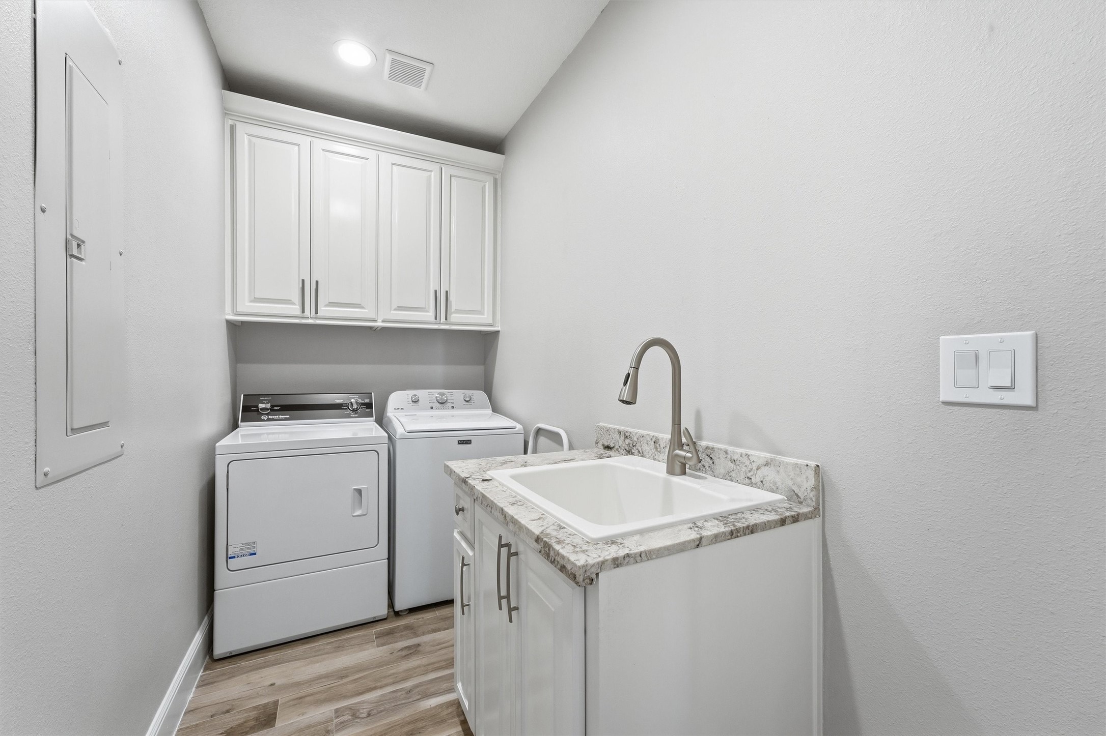 The laundry room is ready to
keep life organized with built-in
cabinetry, workspace for folding
or sorting, and the convenience
of having everything neatly
tucked away yet easily
accessible.