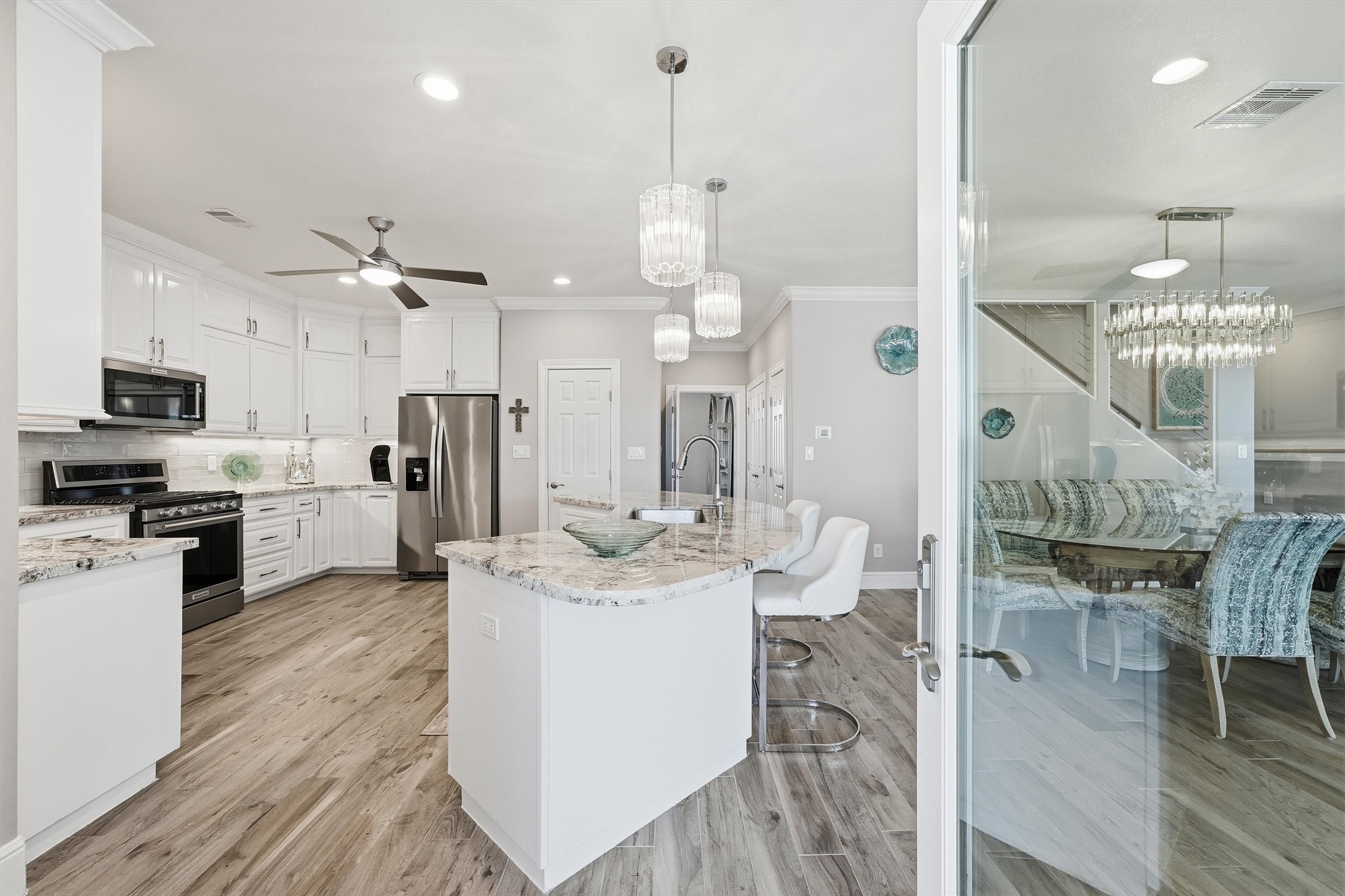 The heart of the home is bright,
stylish, and beautifully
connected, with a large island,
modern glass fixtures, bar
seating, and an open-concept
design made for gathering with
family and friends.