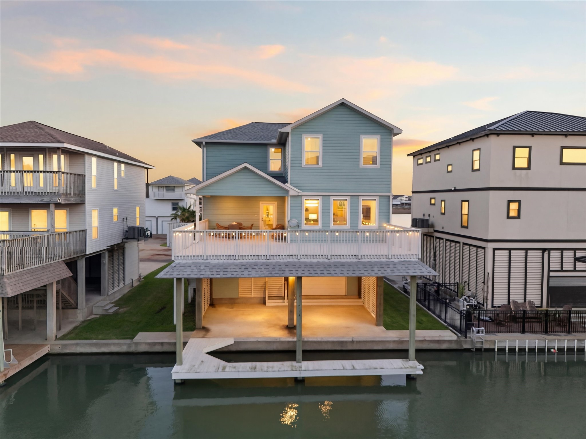 From the canal side, this home
truly shows off its waterfront
appeal with an expansive
balcony above, covered outdoor
living below, and direct access to
the private dock and slip.