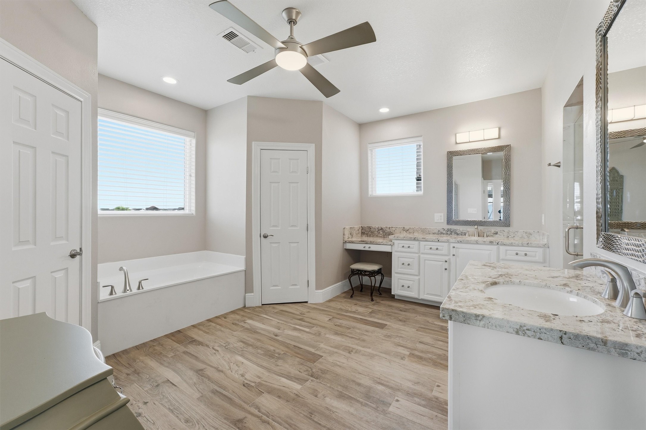 The primary bathroom delivers a
spa-like start and finish to each
day with dual sinks, abundant
counter space, a soaking tub,
and plenty of room to spread out
in comfort.
