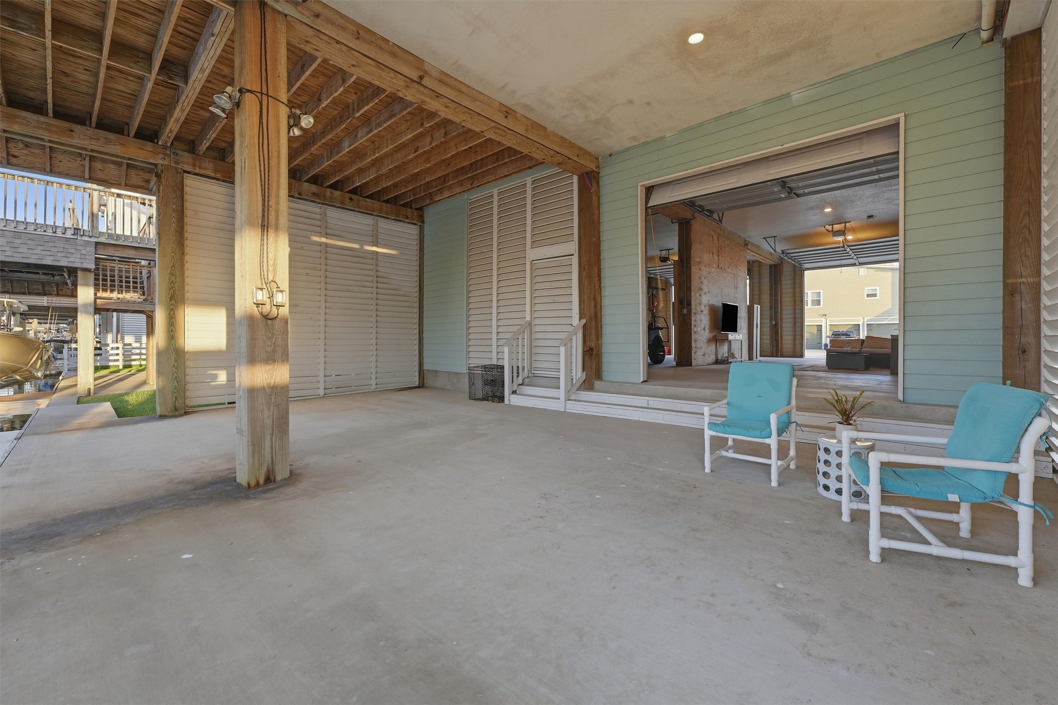 The covered ground-level patio expands the homes entertaining space with plenty of room to dine, lounge, and gather just steps from the canal, dock, and boat slip.