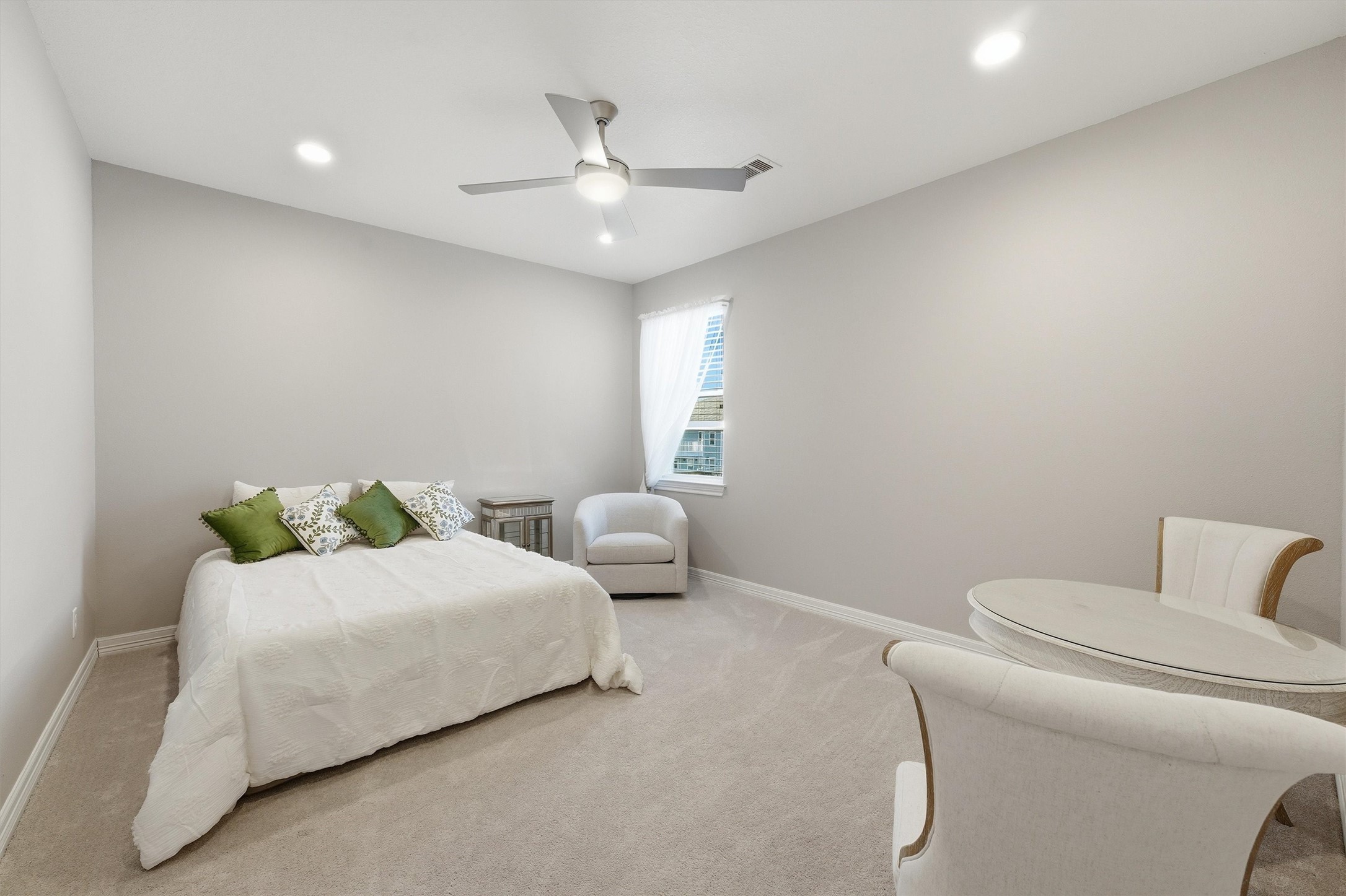 This upstairs bedroom offers a
spacious, comfortable setting for
family or guests, with plush
finishes and easy access to the
upper-level bathrooms.