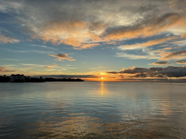 Calm water, wide-open skies,
and glowing evening light create
the kind of peaceful coastal
backdrop that makes coming
home feel like a retreat.