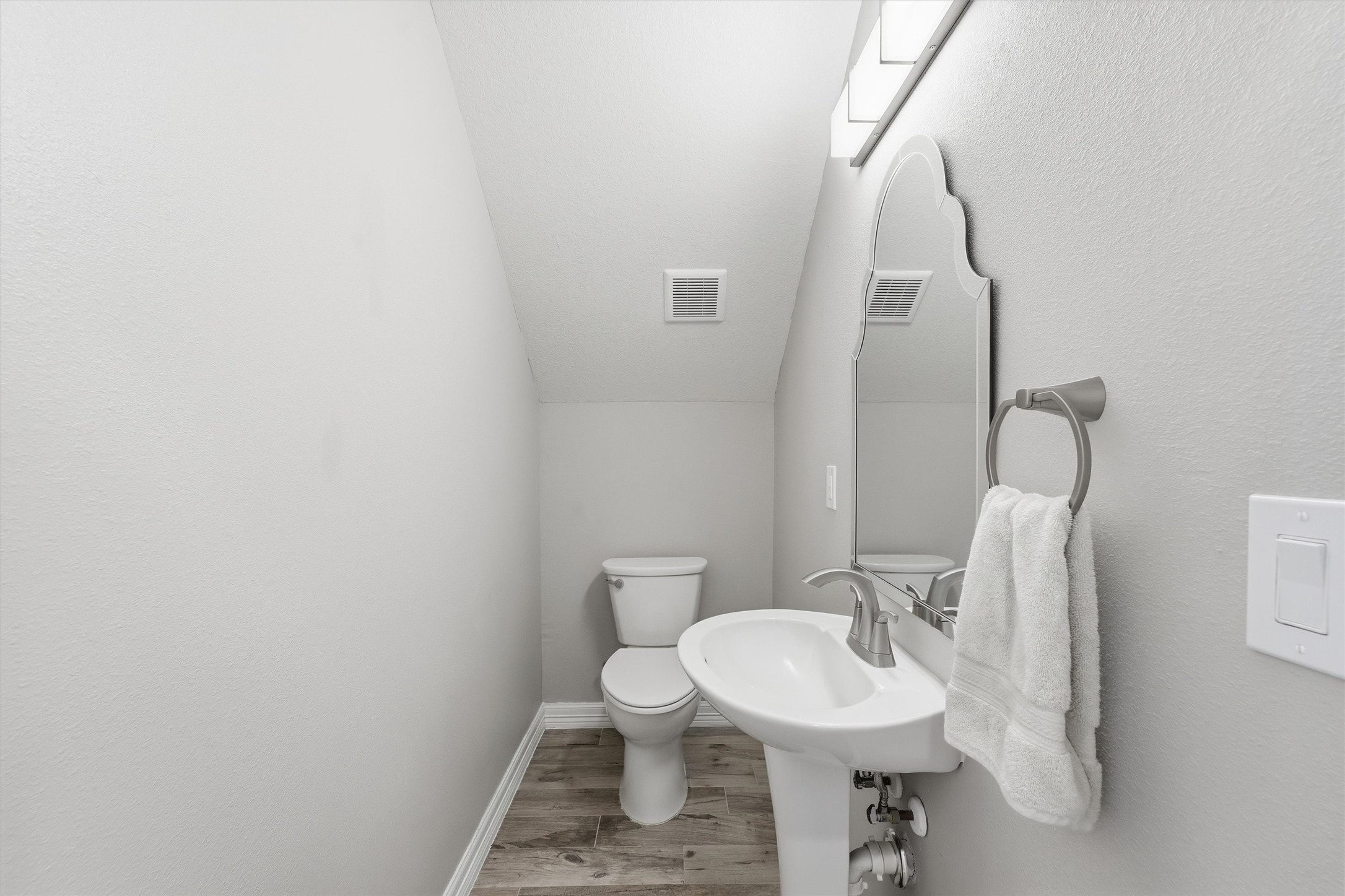 Perfectly placed for guests, this
stylish powder bath adds
convenience to the main level
with a clean, modern look and
polished finishes.