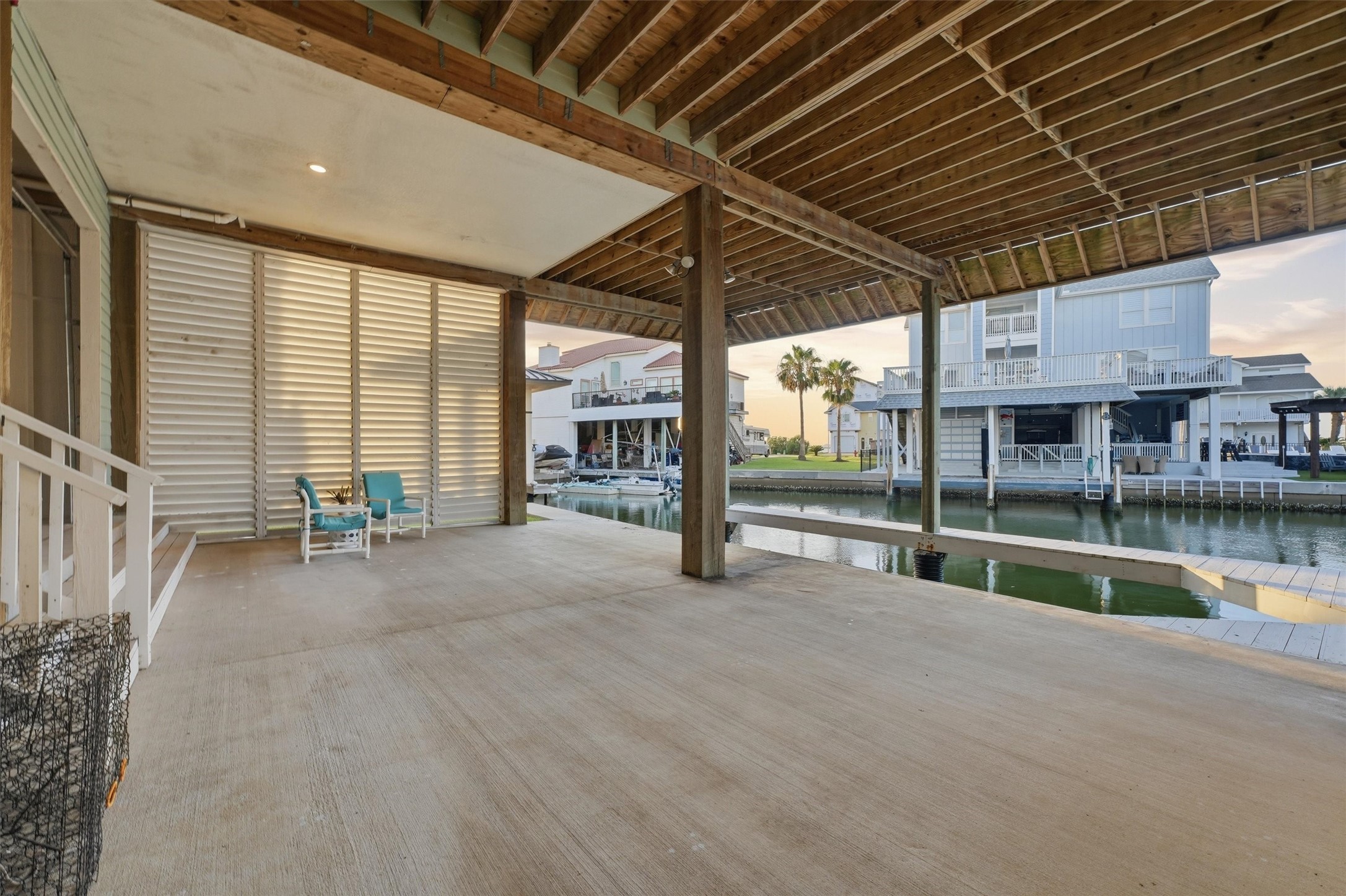 The ground-level outdoor living
area is made for laid-back
waterfront entertaining, with
plenty of covered space to
gather, dine, and enjoy the
breeze just steps from the canal
and boat slip.