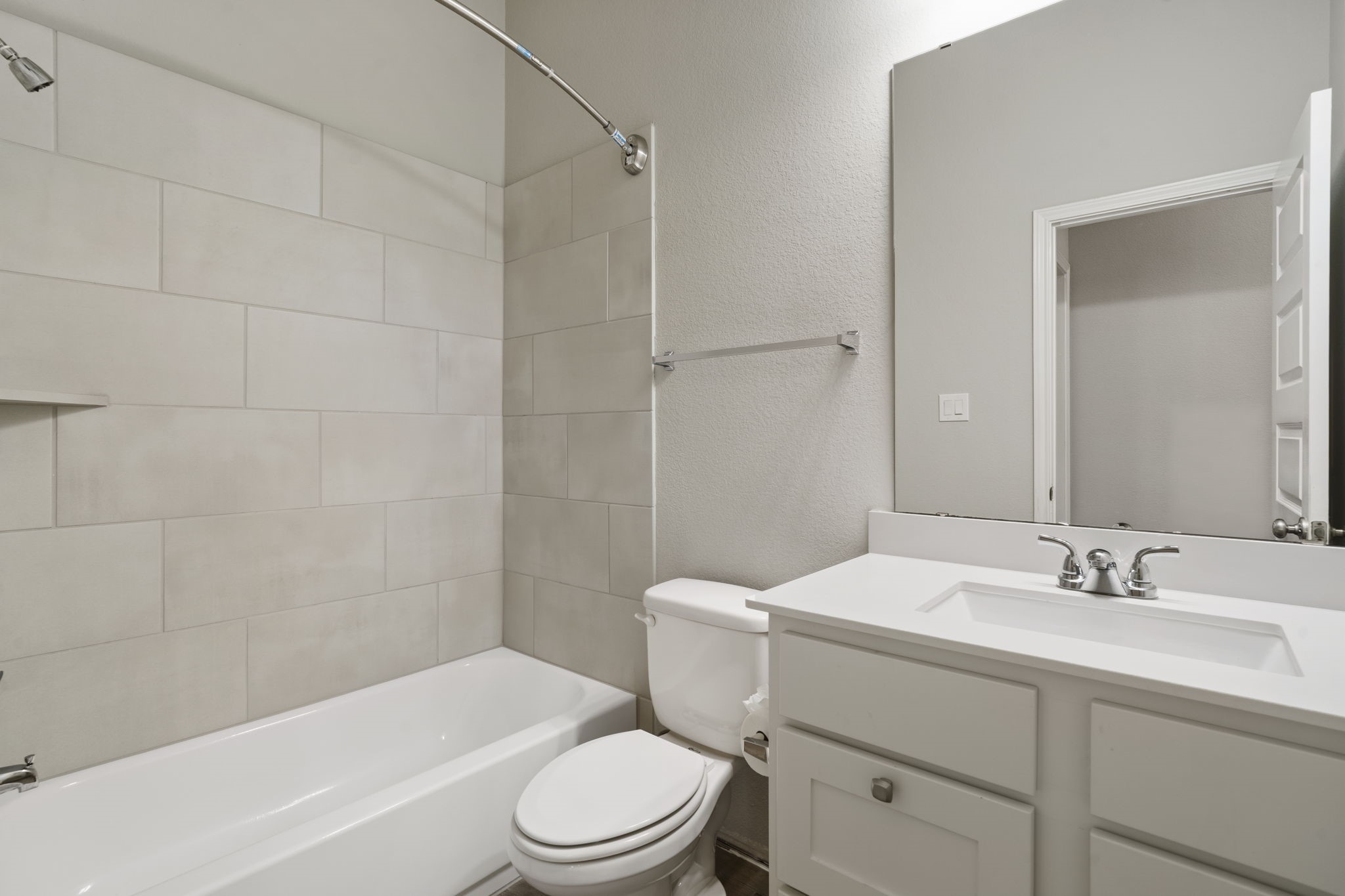 Full bathroom with a tub-and-shower combination, shared by the two secondary bedrooms.