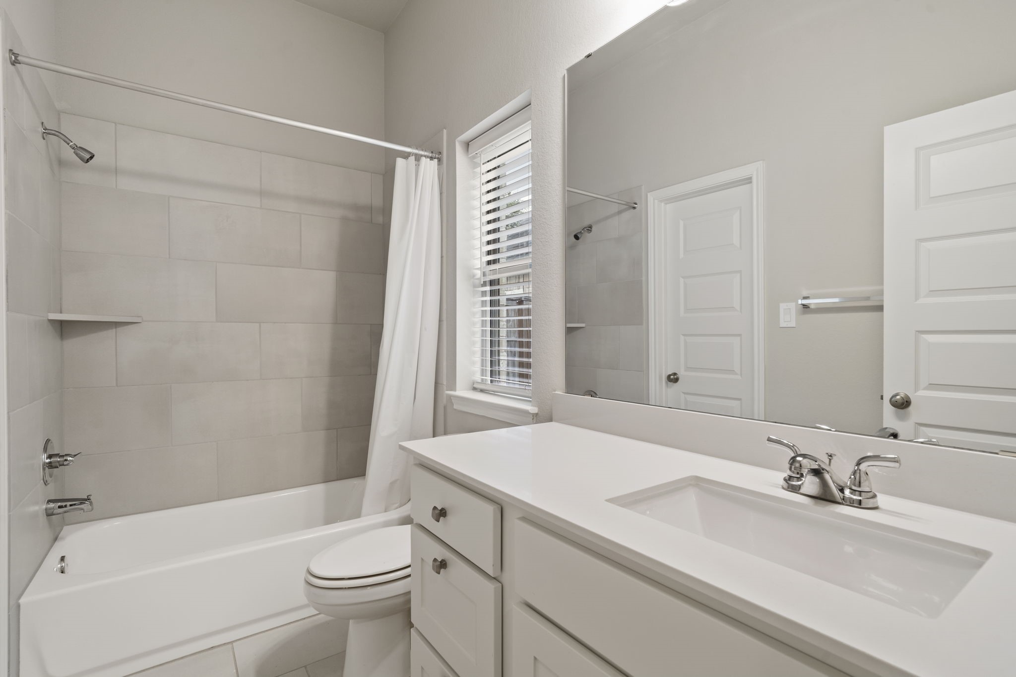 One of three full bathrooms, offering added convenience for family and guests.