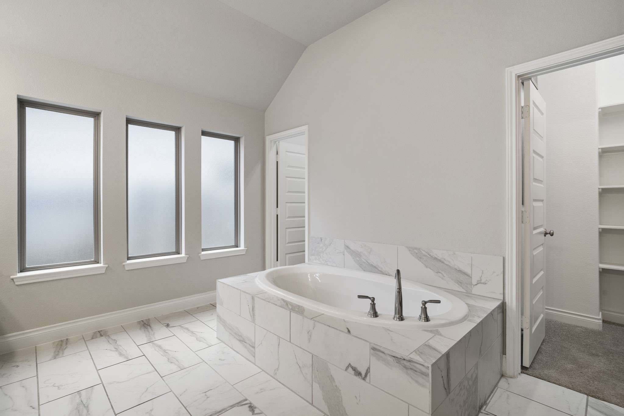 Privacy windows fill the owners bath with soft natural light while maintaining a peaceful, secluded feel.