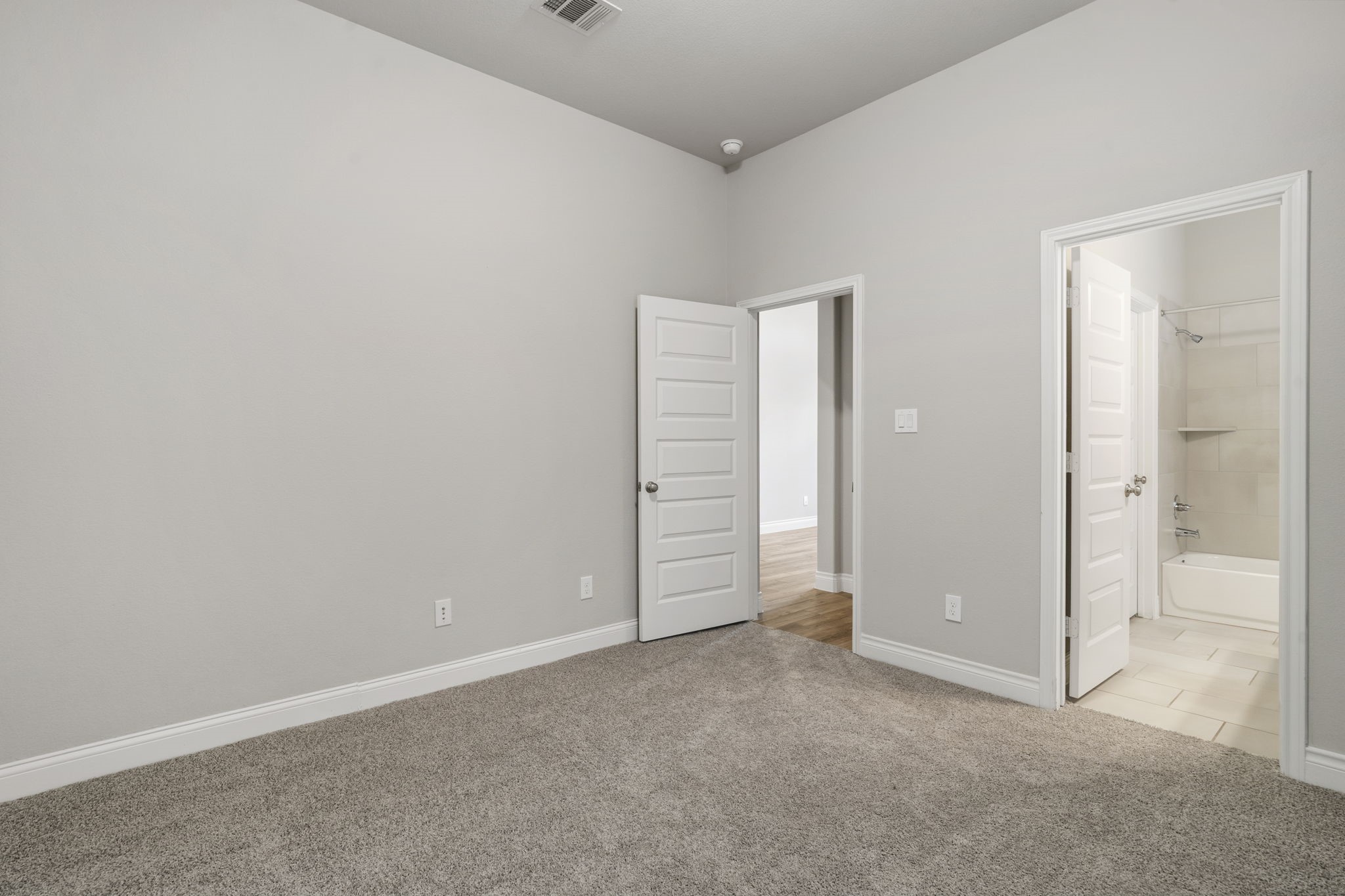 View toward the guest room entrance and the doorway to the en-suite bathroom.