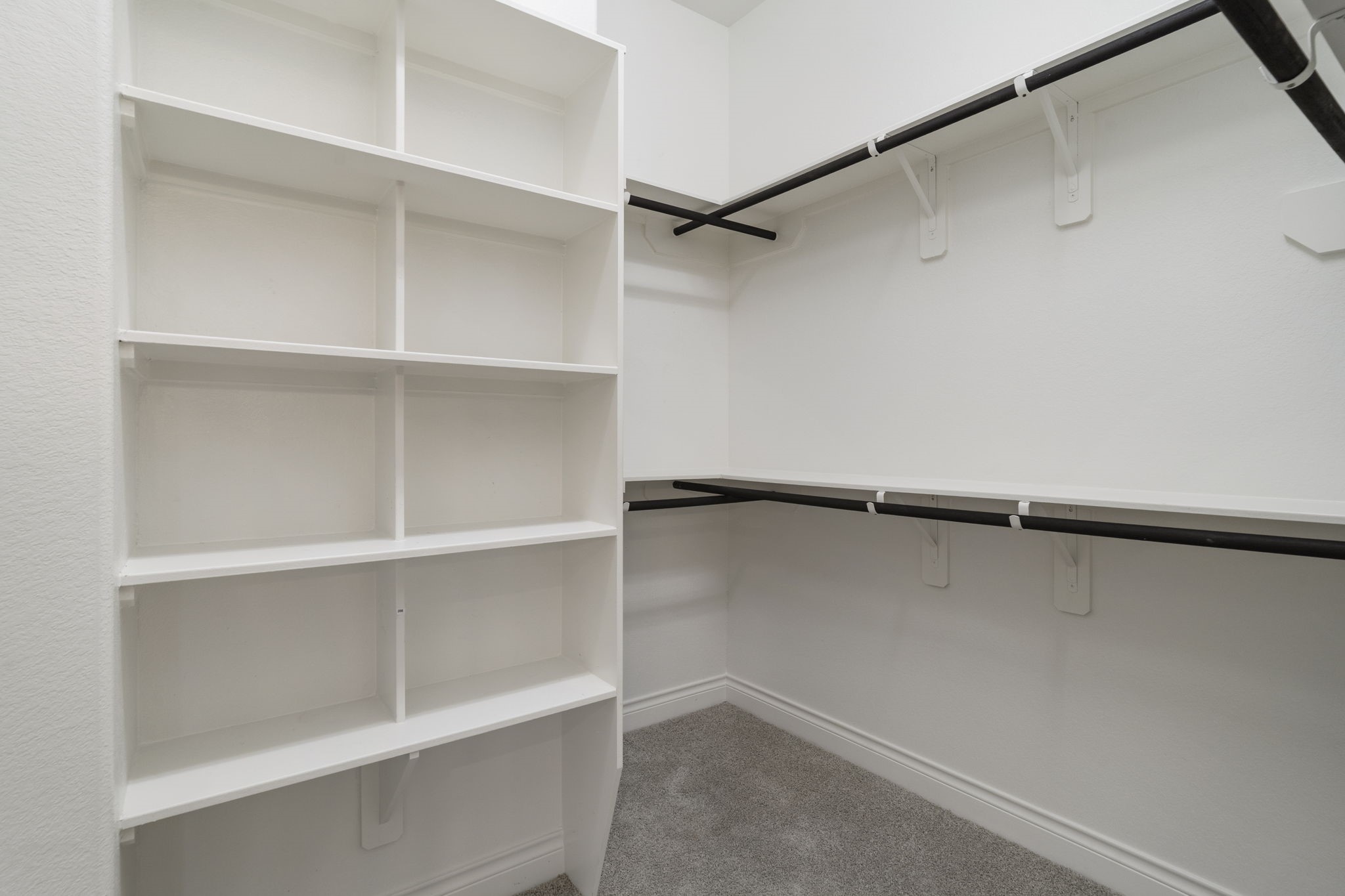 The owner's suite features TWO walk-in closets with hanging racks and built-in shelf storage.