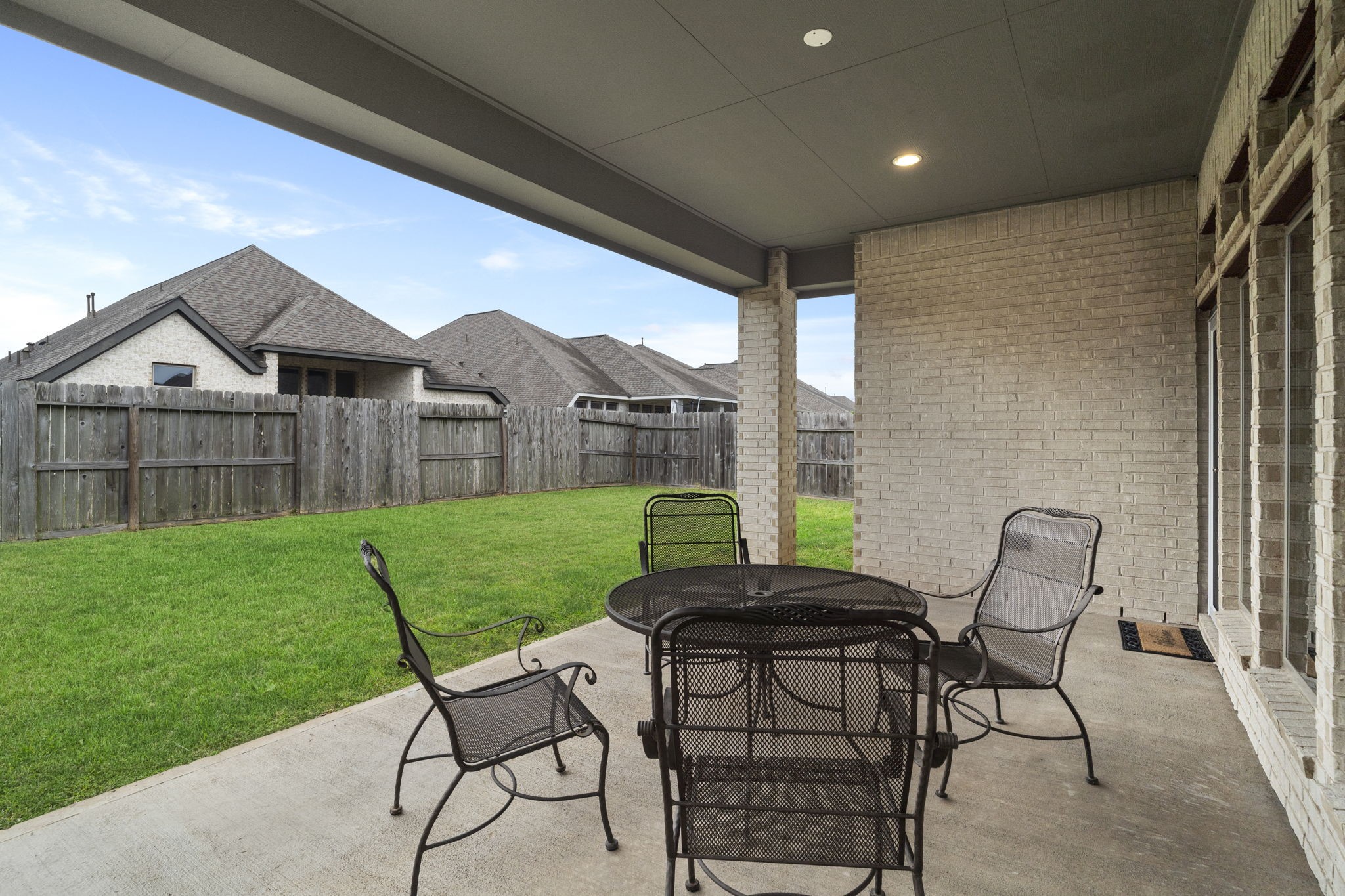 Enjoy the covered backyard patio for outdoor dining and relaxation in any weather.