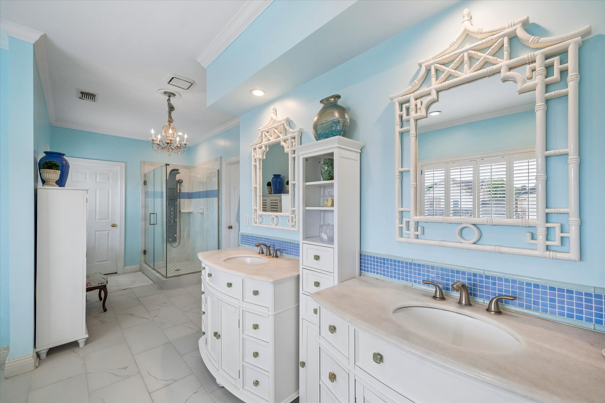 Stylish vanities give you plenty of storage. The blue tile accent adds a nice touch!