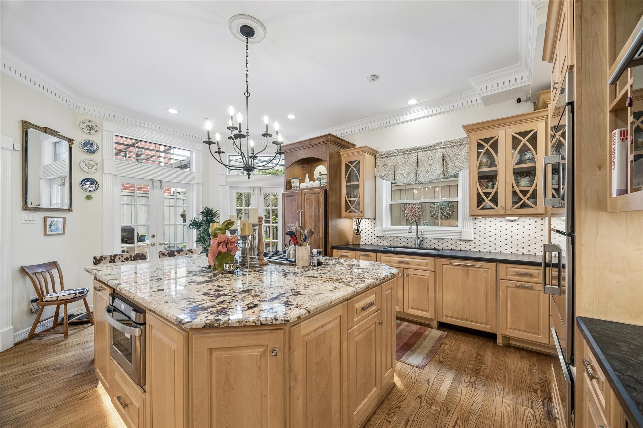 This chef's kitchen is the heart of the home! The kitchen features an oversized island with a Bosch gas cooktop, Sharp drawer microwave, and more storage than you can dream of! All cabinets and drawers are soft close. The kitchen also features two trash pull outs, two lazy Susan cabinets, and two spice rack pull outs.