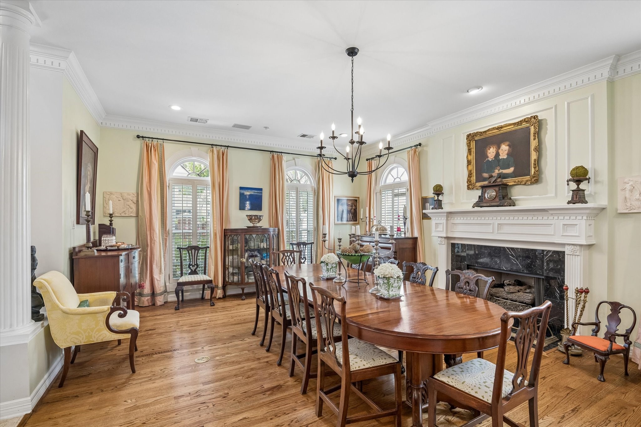 To the left of the entryway is an airy formal dining room. Complemented by a large fireplace with a stone surround, this room is the perfect setting for entertaining.