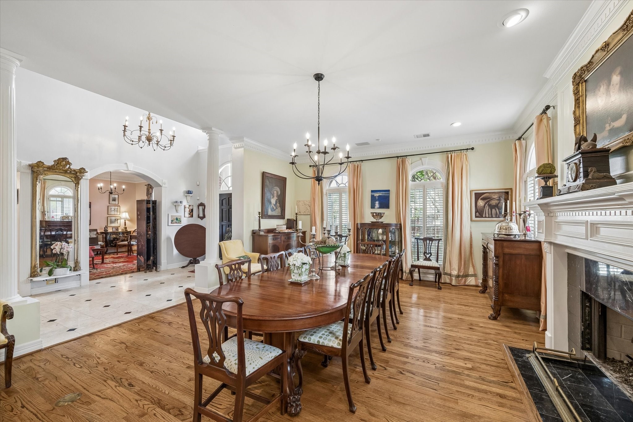Hardwood floors, walls of windows, and dental molding accent the space.