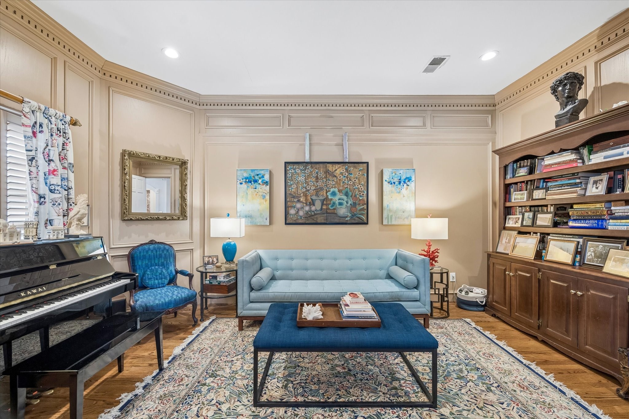 Just off the dining room is the library. Pocket doors allow this room privacy from the dining room. Could be used as a study or den as well! Notice the painted wainscoting and dental molding.