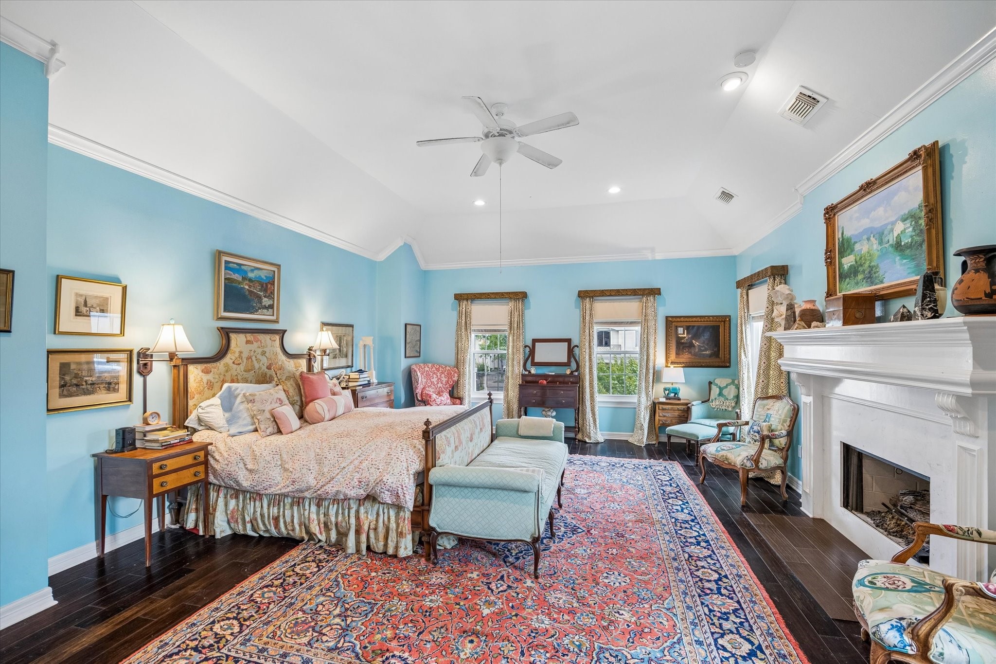 The dark hardwood floors set the primary apart from the rest of the home. Also features crown molding and a tray ceiling.