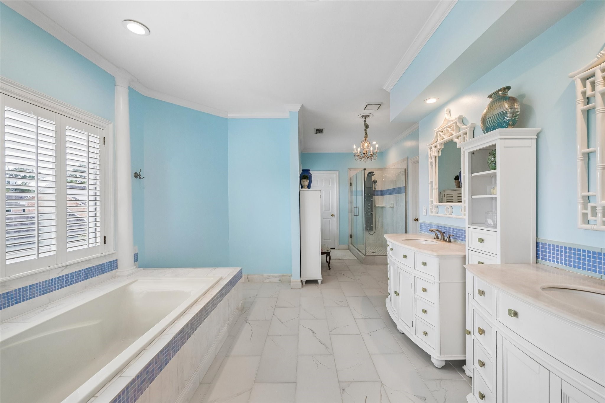 This spa-like primary bathroom is the perfect addition to the primary suite! Featuring dual sinks, separate glass shower, soaking tub, and two walk-in closets.