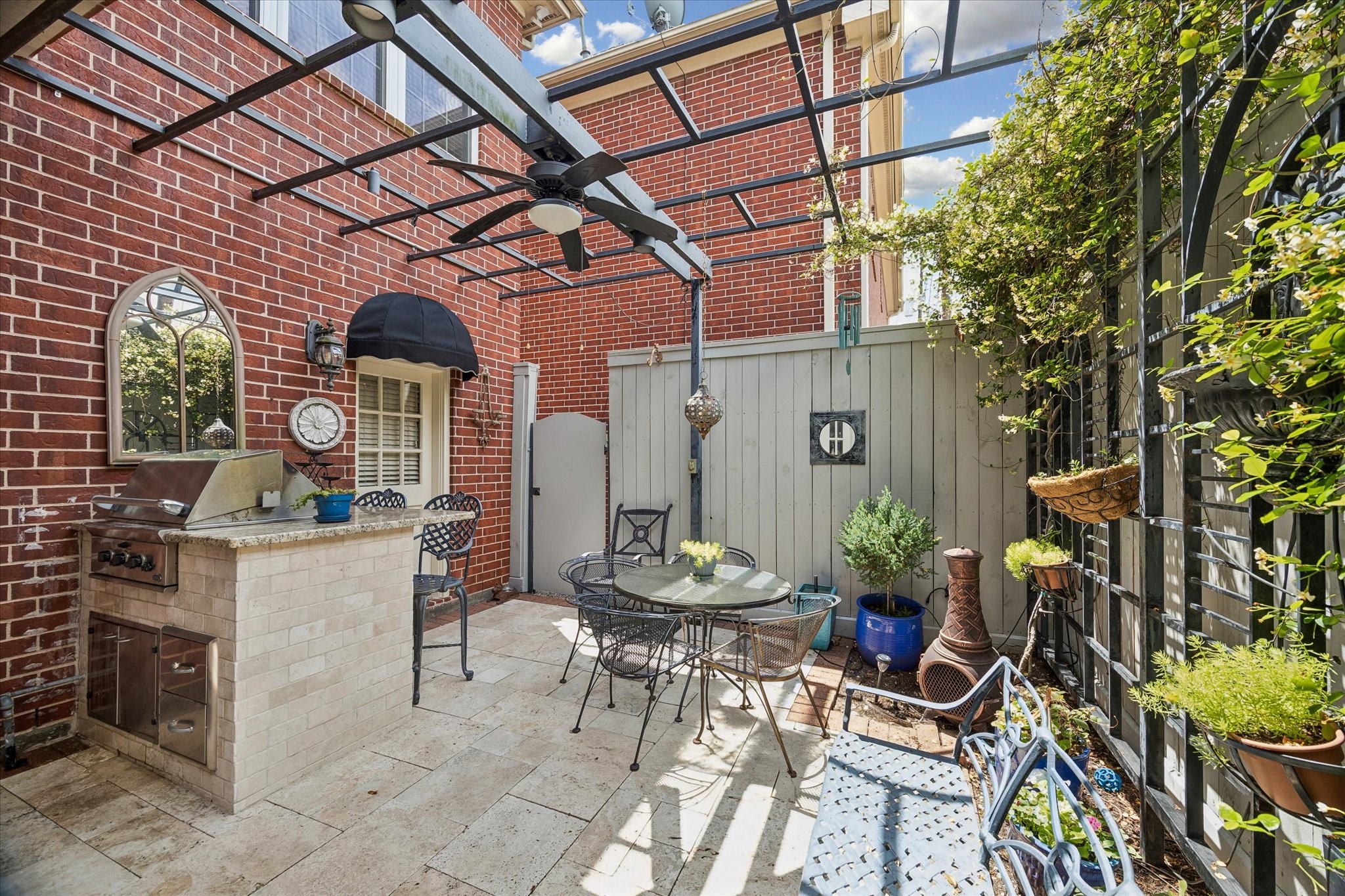 Just off the kitchen is the back patio. Featuring travertine tile, a gas grill, and pergola, this is the perfect place to wind down.