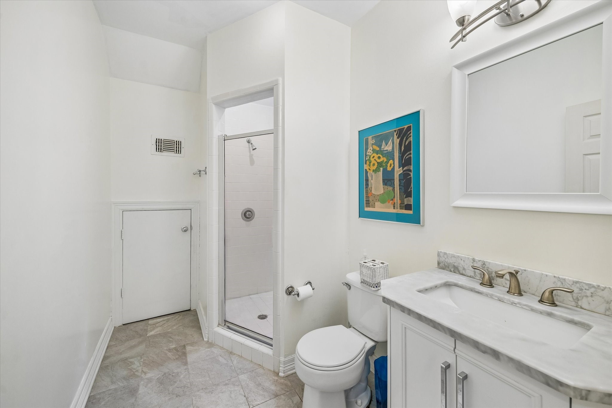 The third floor full bathroom features a separate shower and under sink storage. Also features access to the attic.