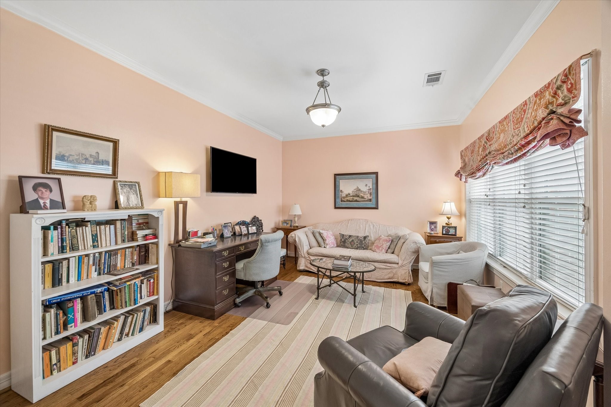 The upstairs office could be a fourth bedroom. Features a large closet, hardwood floors, and crown molding.