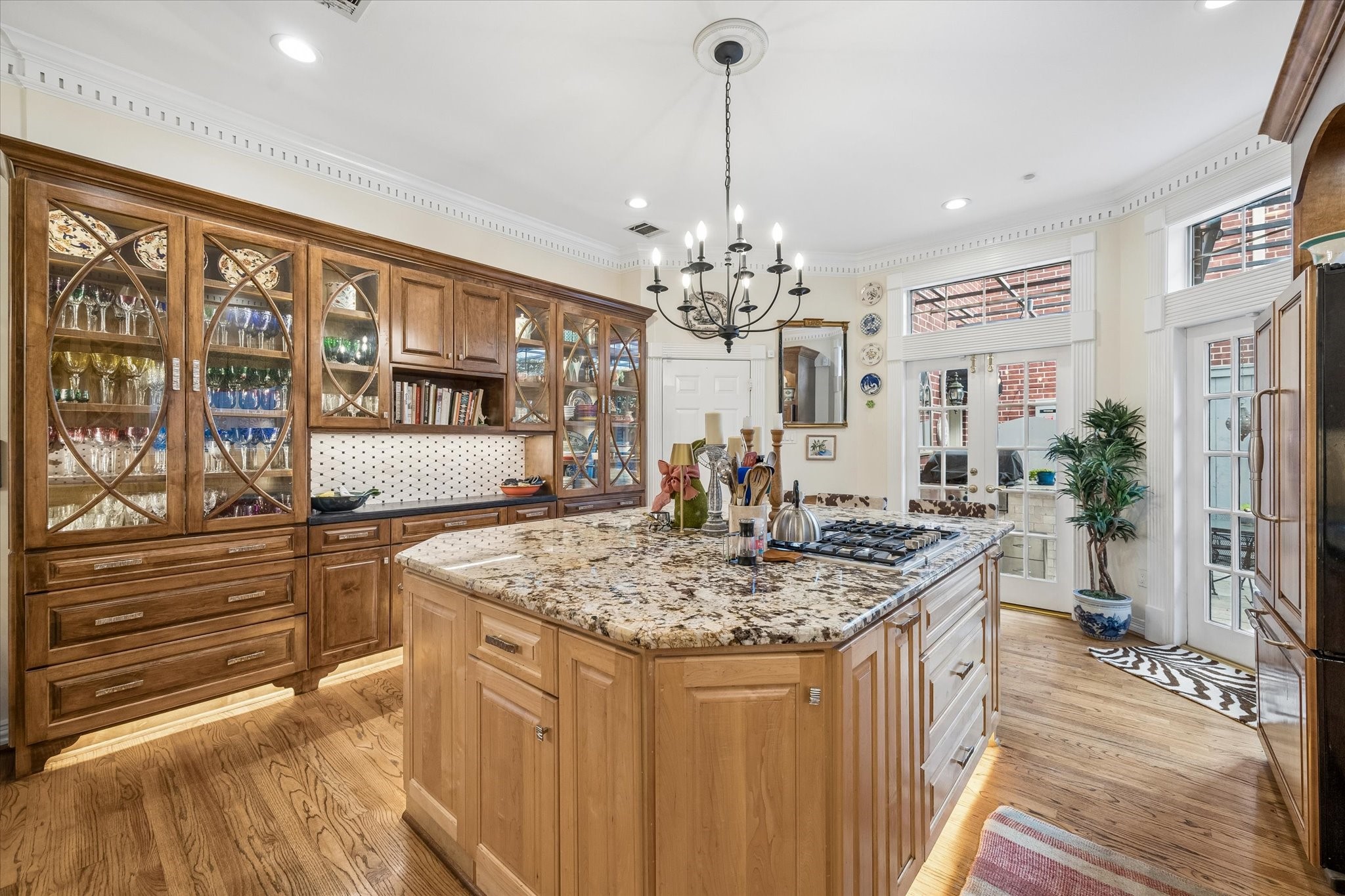 So warm and inviting! The kitchen also has access to the two car garage and back patio. The garage features storage shelves and a work bench.